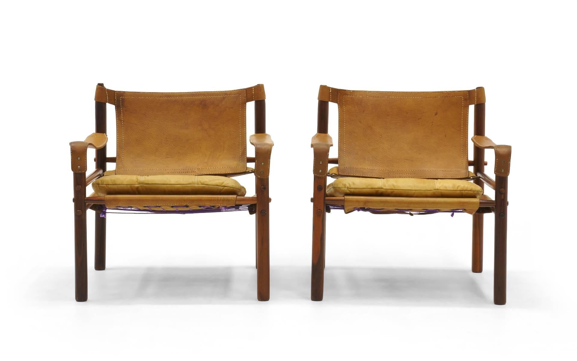 Early pair of Sirocco chairs designed by Arne Norell, Sweden, 1960s. The rosewood is in very good condition and the saddle leather retains it’s original patina and attractive wear. This pair both retain the original (and usually missing) leather