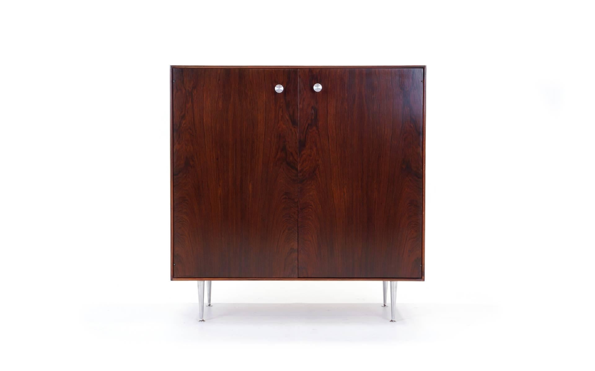 Beautiful, all original, thin edge cabinet in Brazilian rosewood with aluminum legs and pulls.