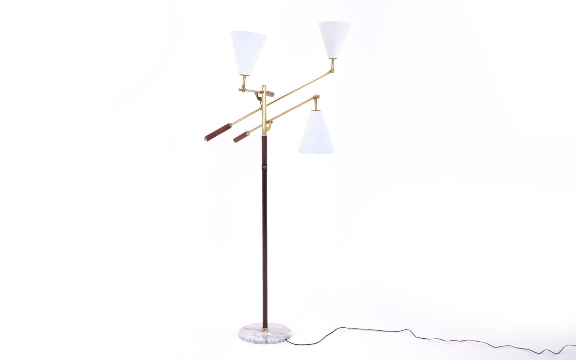 Triennale Style floor lamp featuring brass hardware and stem, white enameled shades, and tobacco colored leather, marble base.  