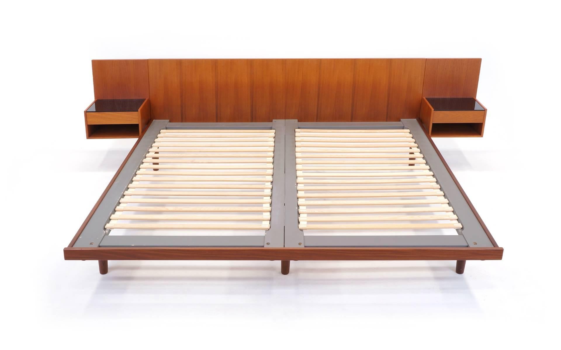 Exceptional and rare king-size bed frame designed by Hans Wegner and made by GETAMA, Denmark. Teak with textured black glass tops on the night stands. Excellent all original condition. Please use the contact dealer button if you have any questions.