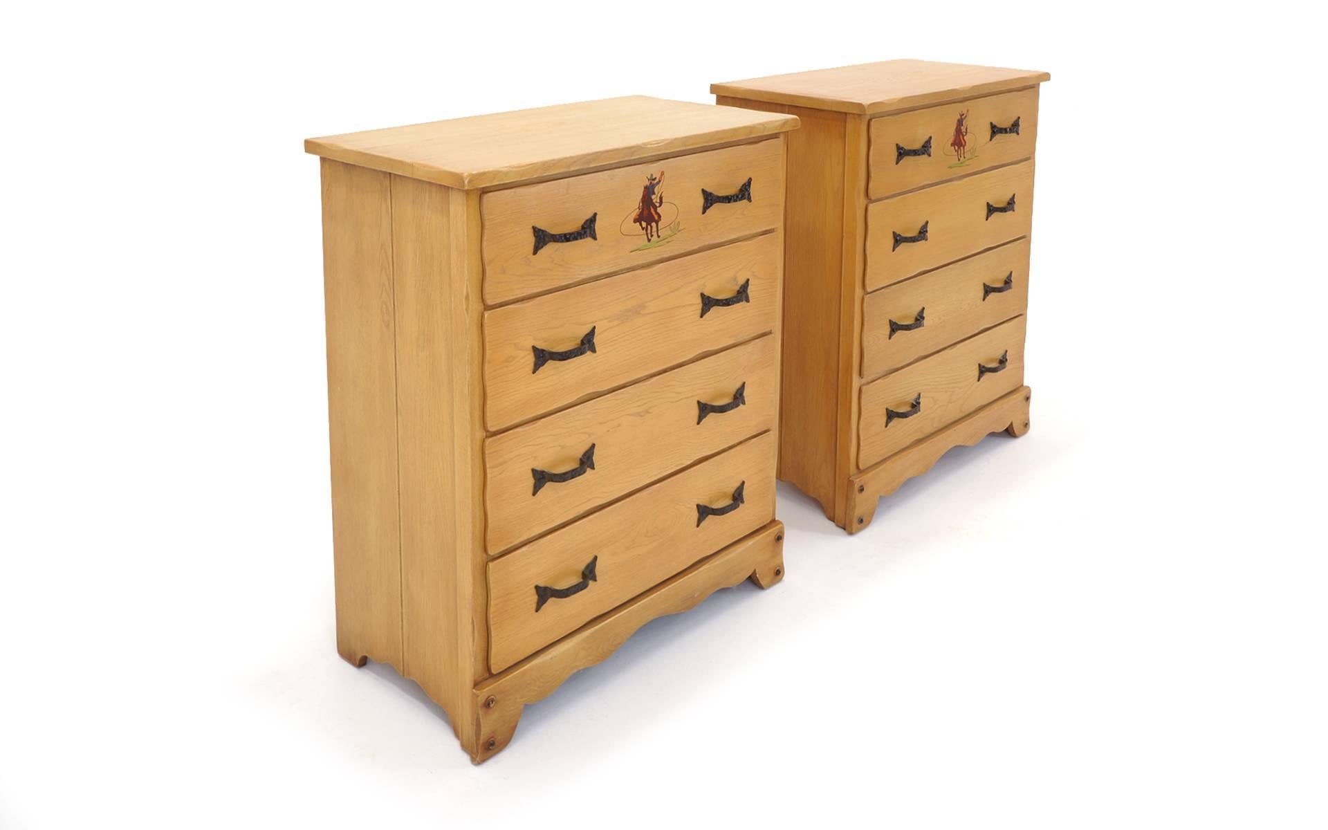 Authentic 1930s Monterey hiboys / dressers. Original warm maple finish with distinct hand-painted Cowboy motifs. Four drawer, plank top, hand-forged, dimpled iron pulls with forked ends. Bracket feet. Branded with monterey on back. Rancho Monterey