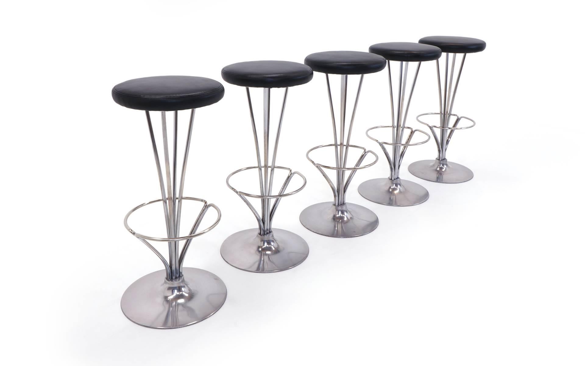 One of the best modern bar stool designs of the 20th century. Super sturdy aluminum and chromed steel construction with expertly reupholstered black leather seats. Signed Fritz Hansen. 31.25 inches tall, base diameter is 13.5 inches and seat