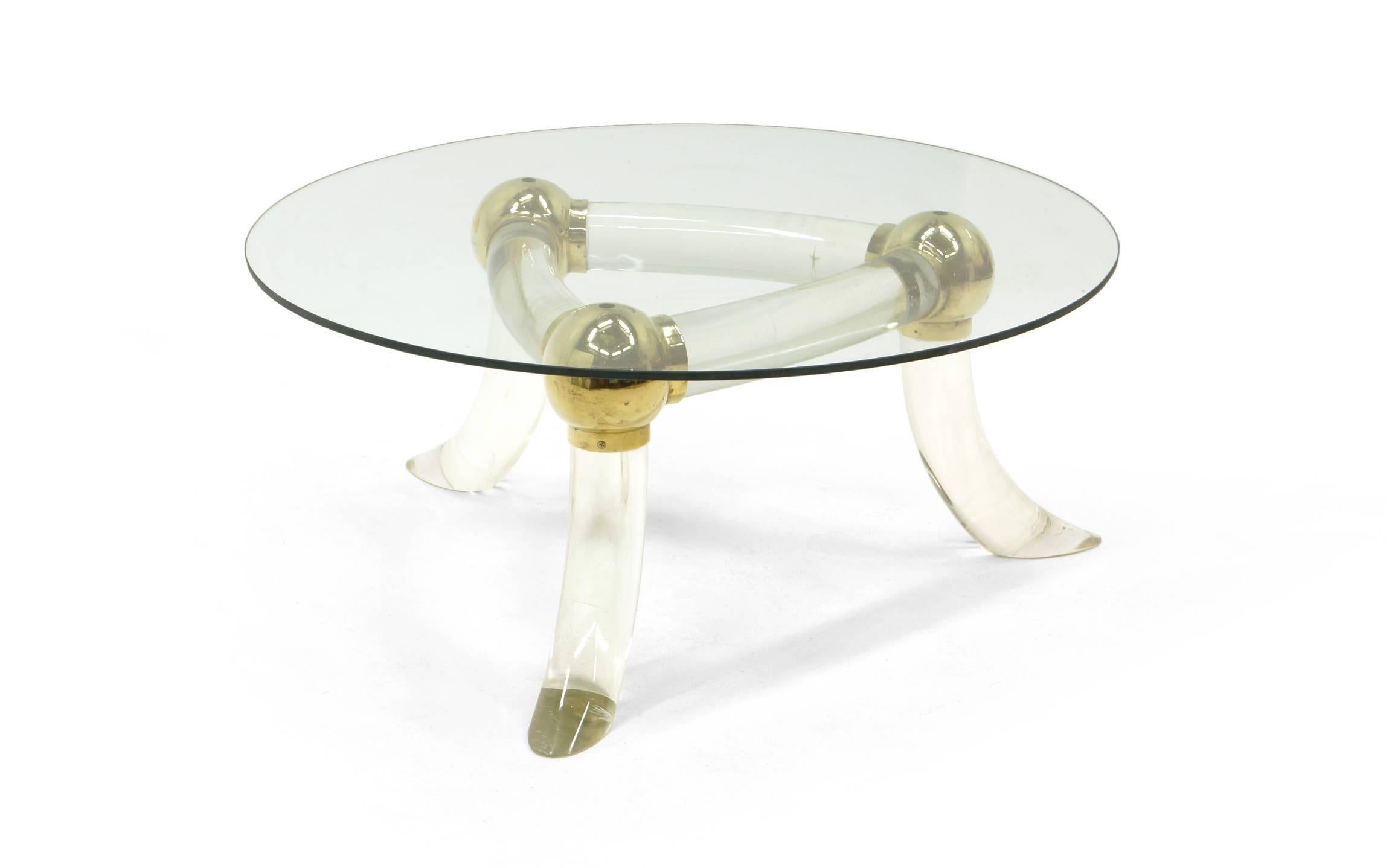 1970s, glass top coffee table. Heavy, solid acrylic tripod base with round brass connectors in the style of Charles Hollis Jones.