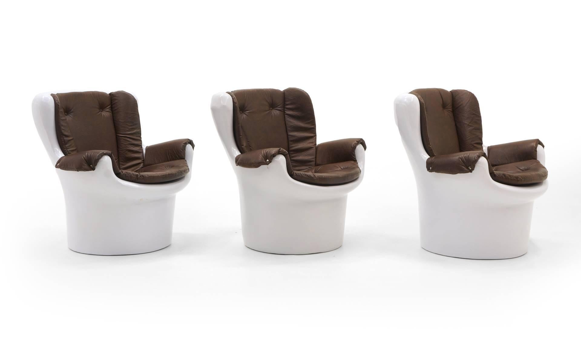 ONLY ONE AVAILABLE.  Molded plastic lounge chairs. Fun, kitschy, mod design. These would be great chairs for a gaming room or party room. Vinyl removable brown vinyl seat pads and arms.