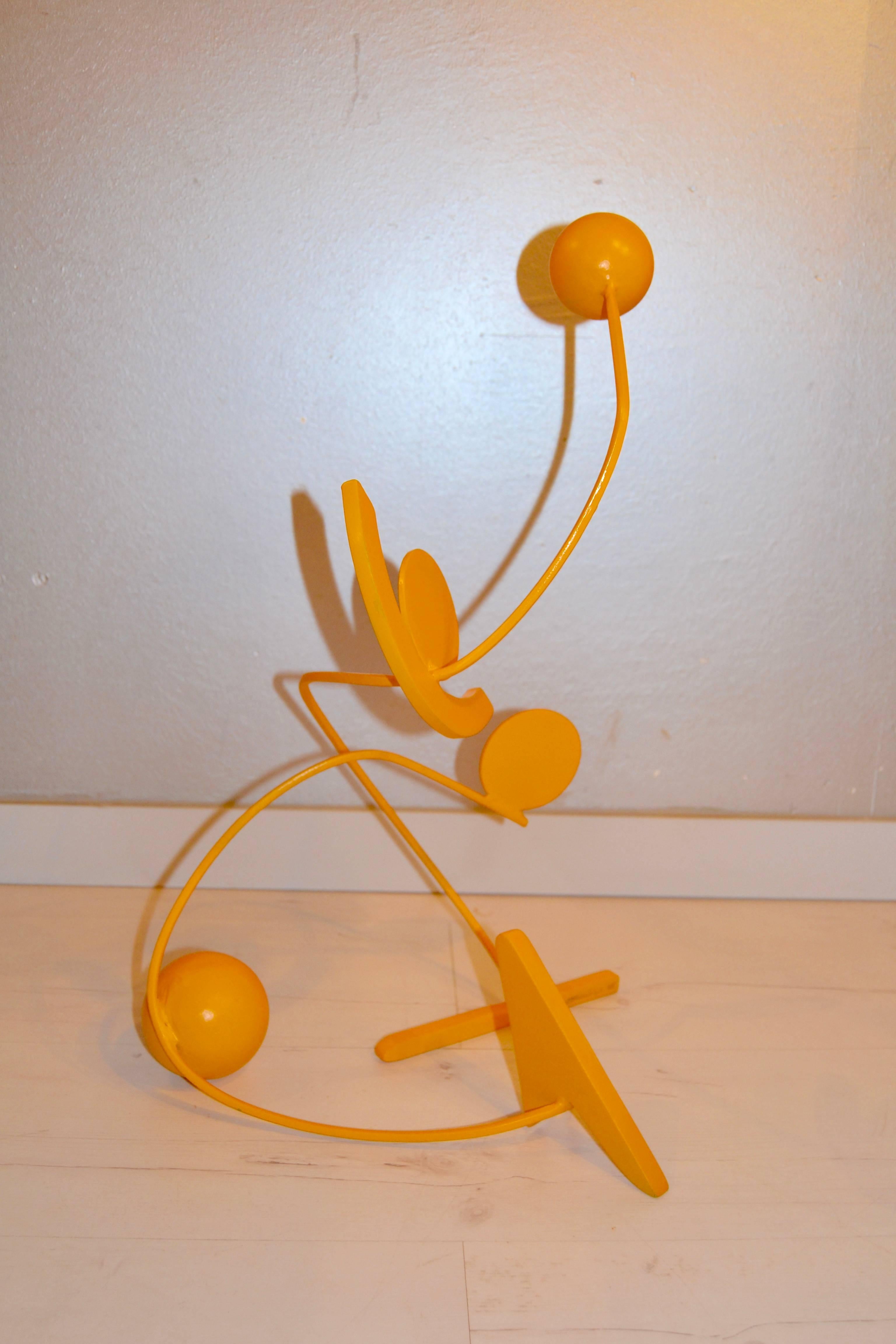 Yellow painted stainless steel sculpture by Giancarlo Caporicci. Signed on the base.