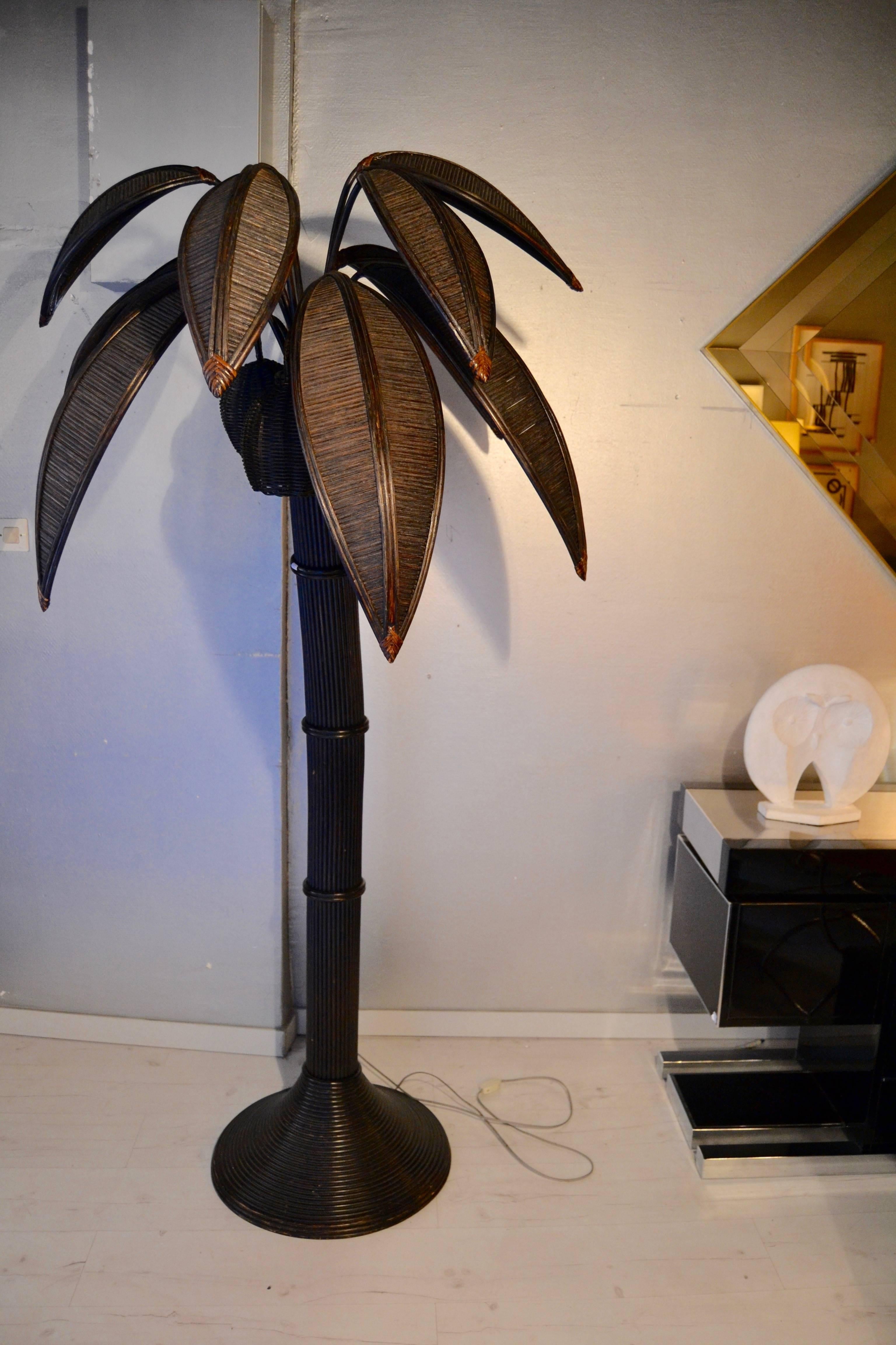 1970s large floor lamp representing a palm tree in bamboo-rattan dark brown. Lamp is composed of three lights how gives a very nice ambiance.
Great vintage condition.