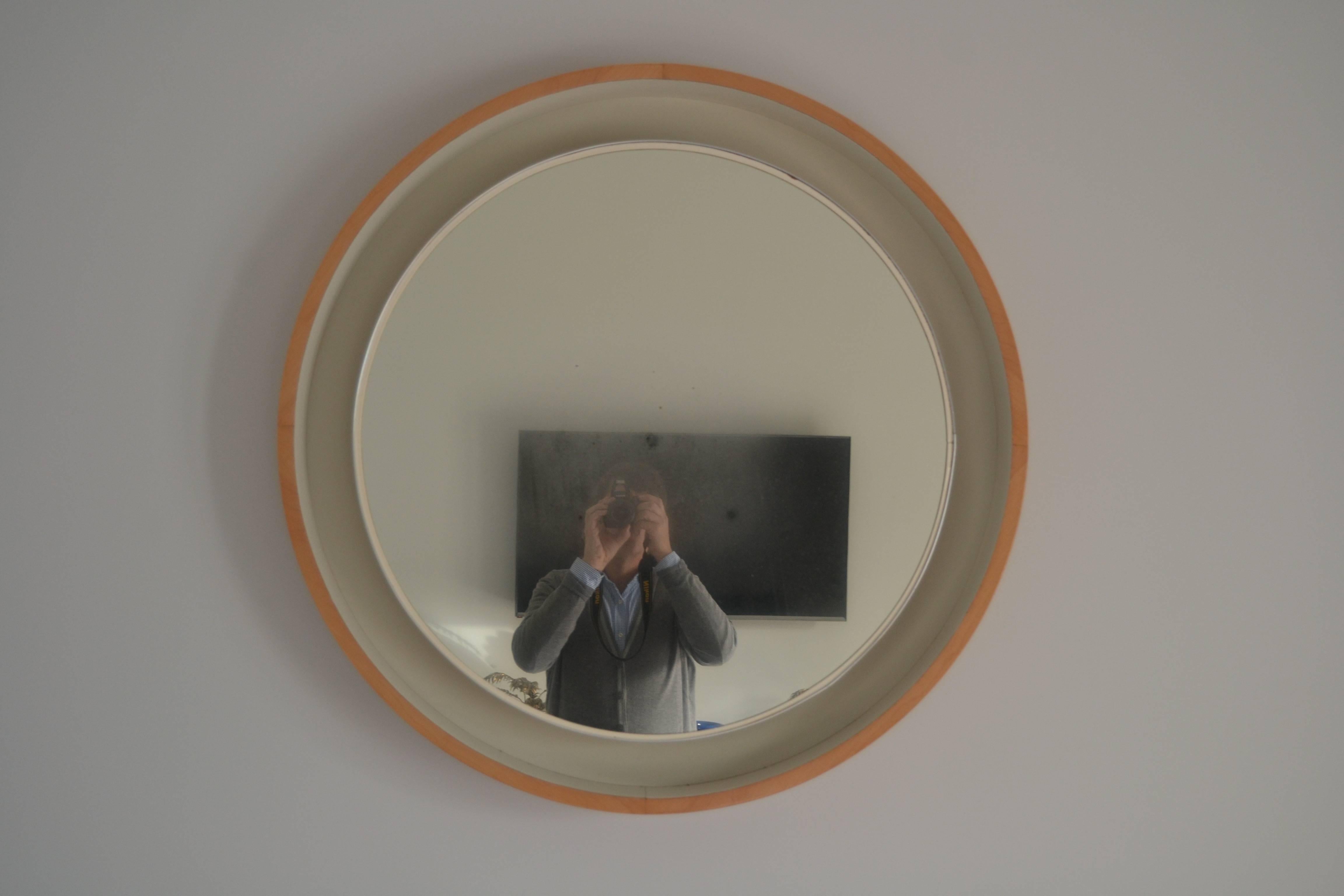 1970s Danish lighted round mirror with light wood frame. Glass mirror has some patina as you can see in the photos. Great lighting effect.