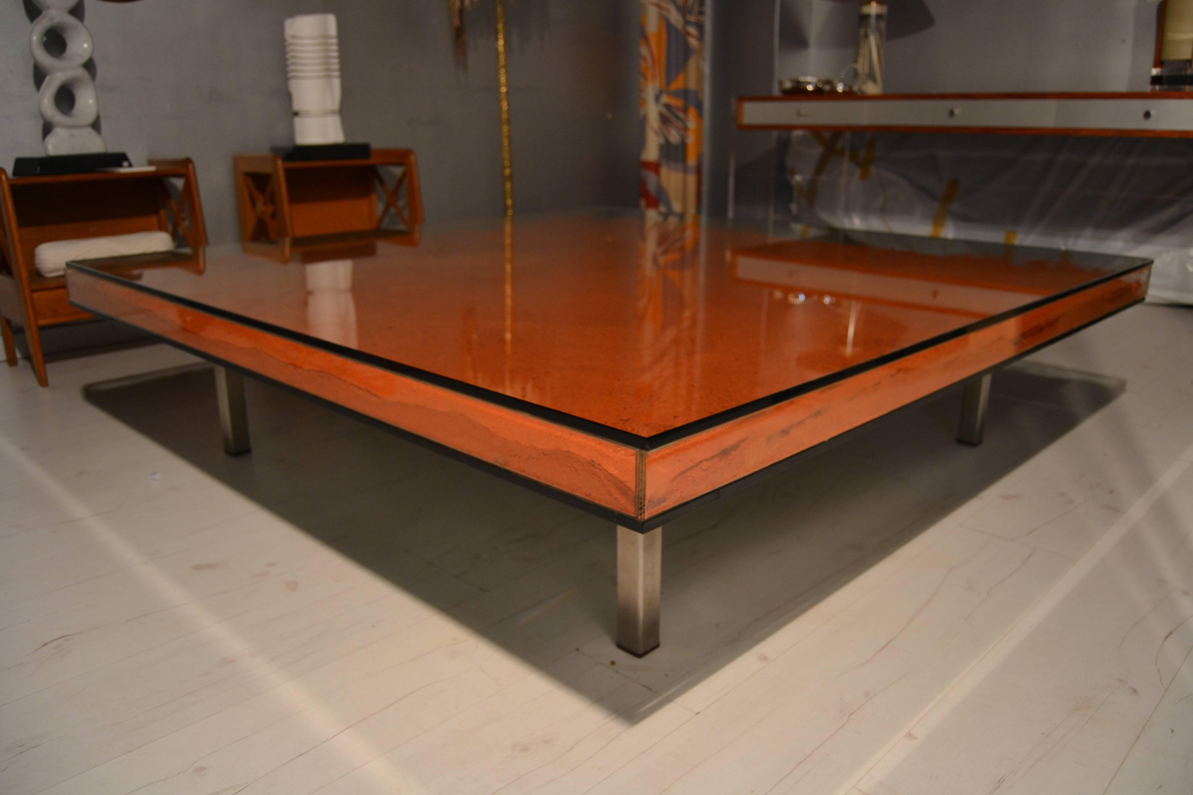 Large coffee table in glass with clay color pigments inside. This table remains the works of Yves Klein in 1960s.