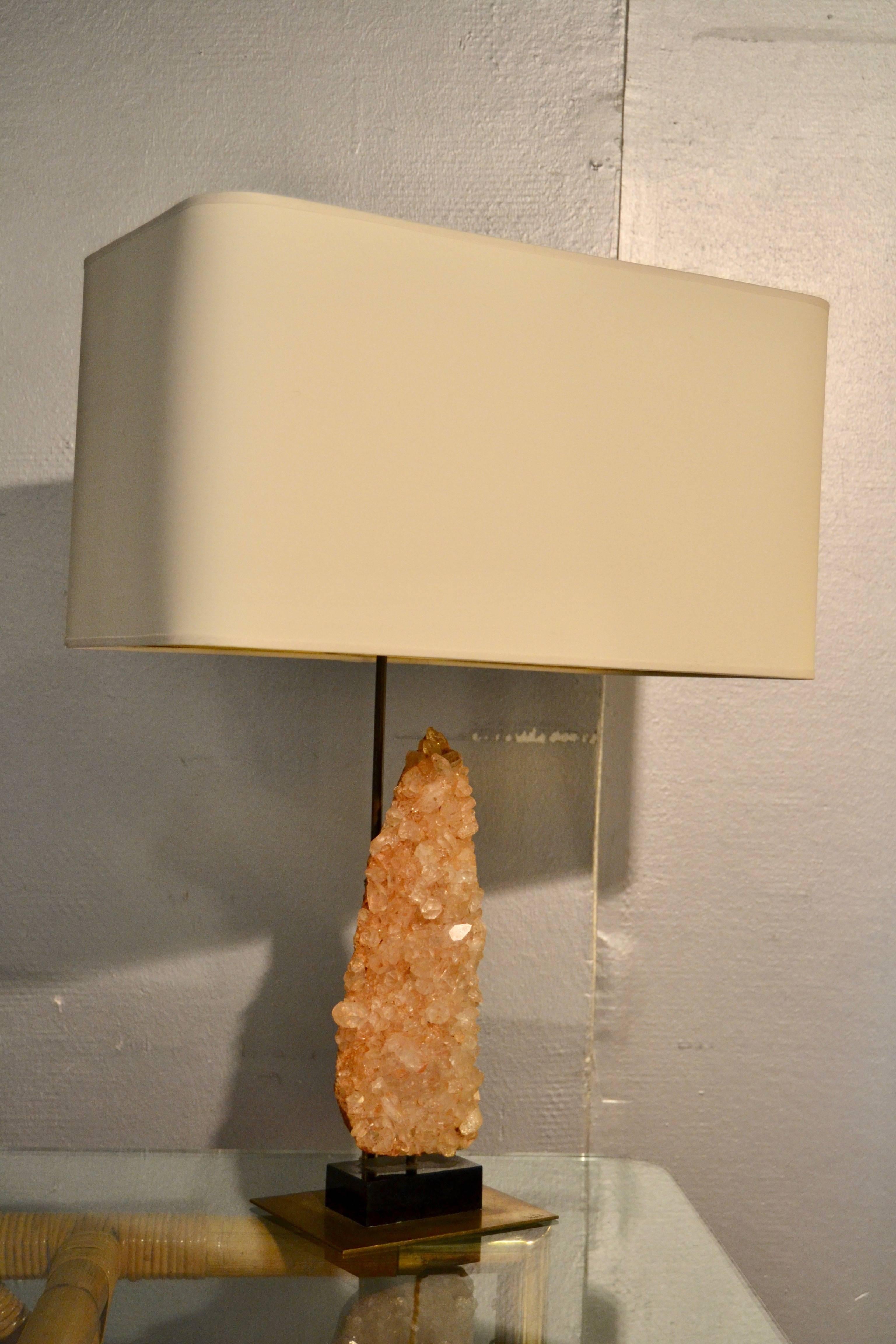 1970s table lamp with quartz rock crystal mounted on brass base
Great condition
New shade with gold interior.