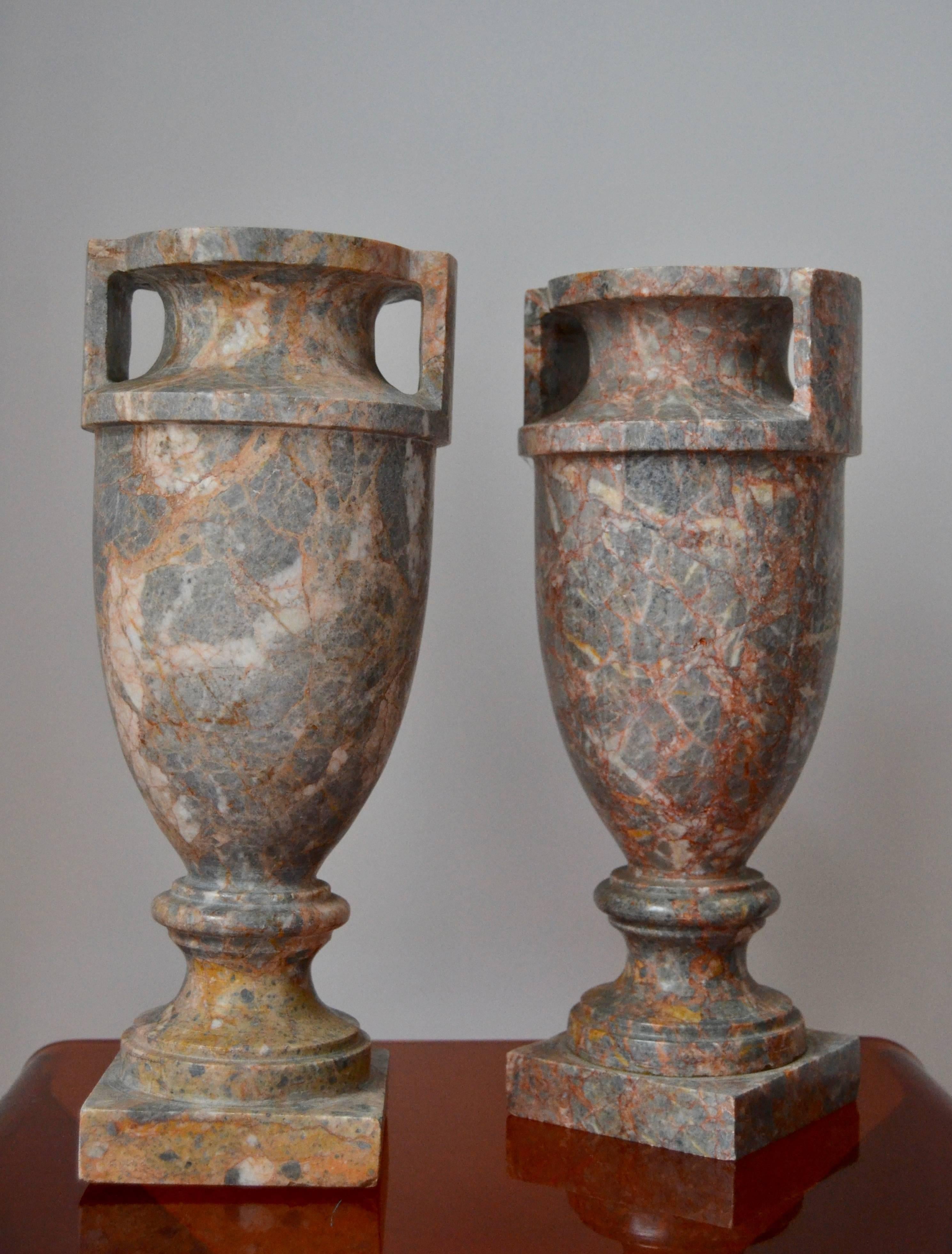 Pair of Italian Marble Urns with red and amber tone.