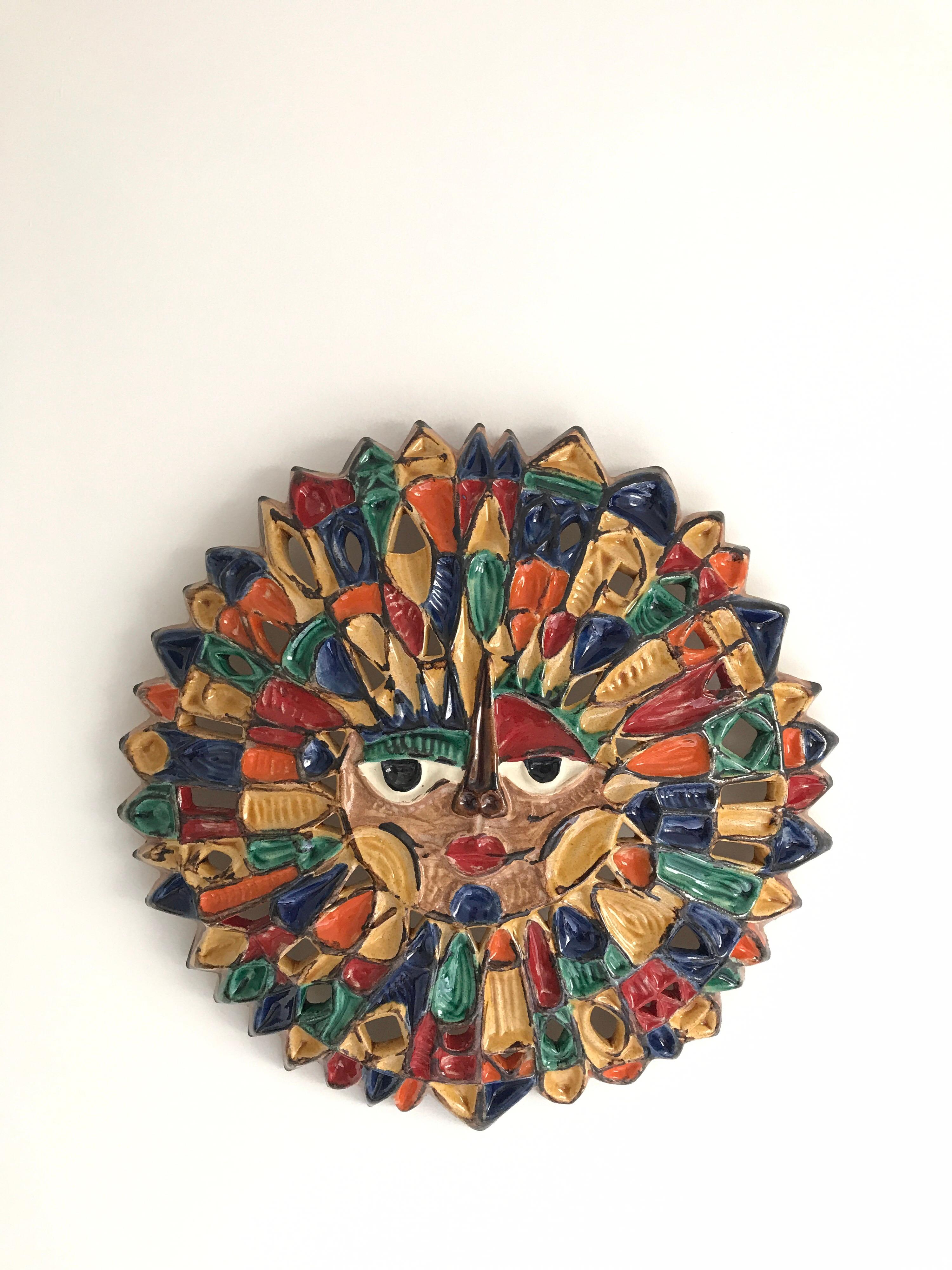 Large ceramic sun in with yellow ,blue orange and green colors
unique piece.