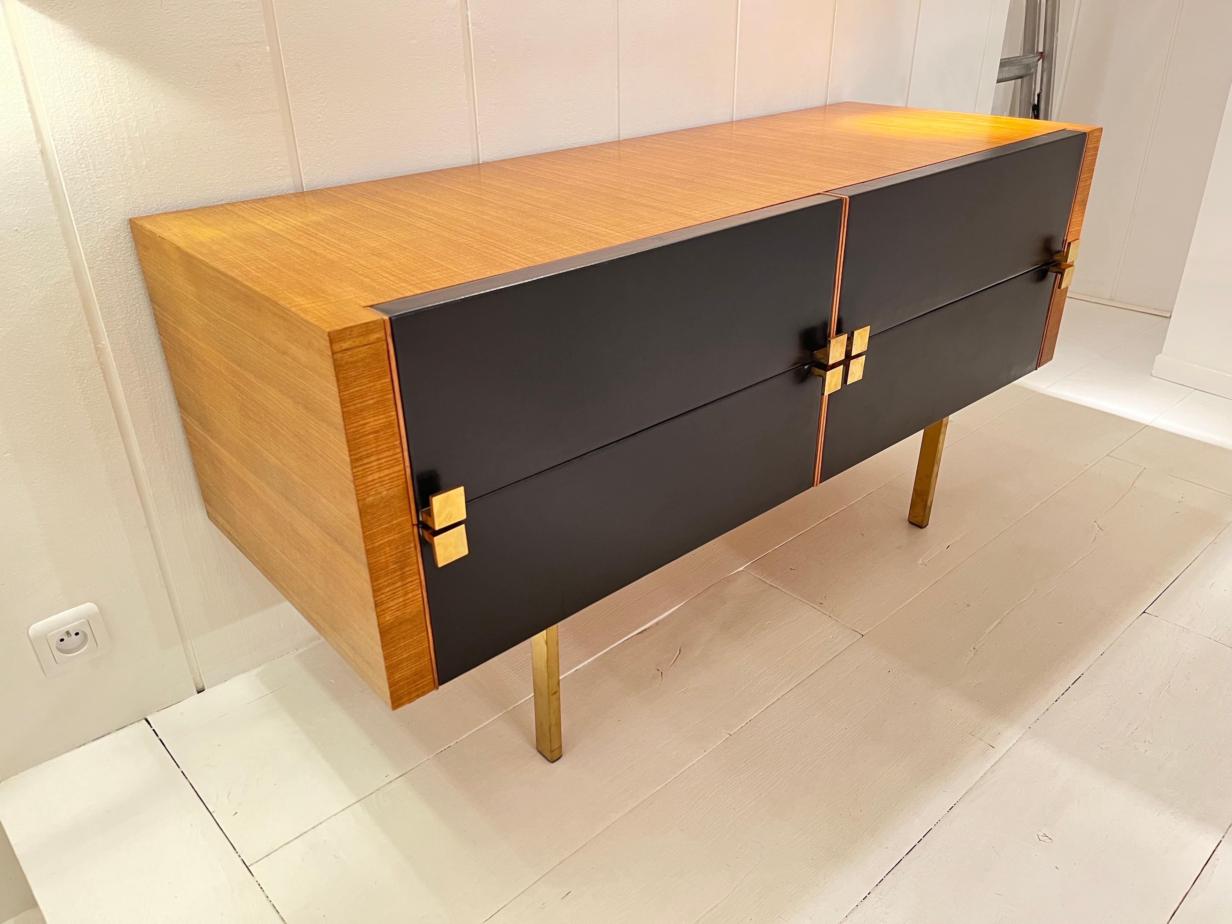 1960s Ashwood chest with brass handles and and Black leathea drawers.
Designe by Roger Landault.
Great vintage condition.
 