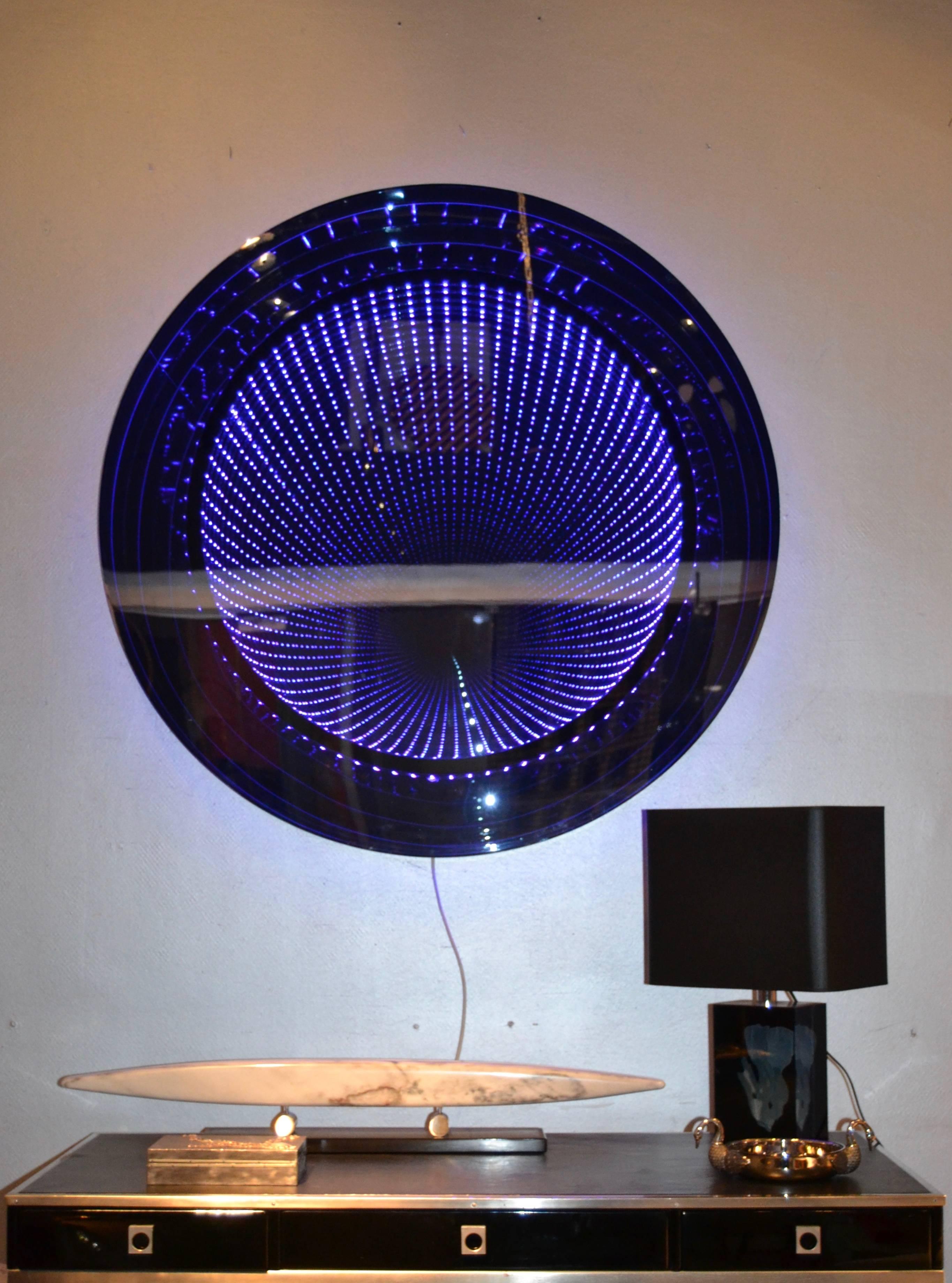 Large infinity mirror by the French artist Raphael Fenice with blue light
The piece is entirely in mirrored Lucite and wen is of looks like a mirror.