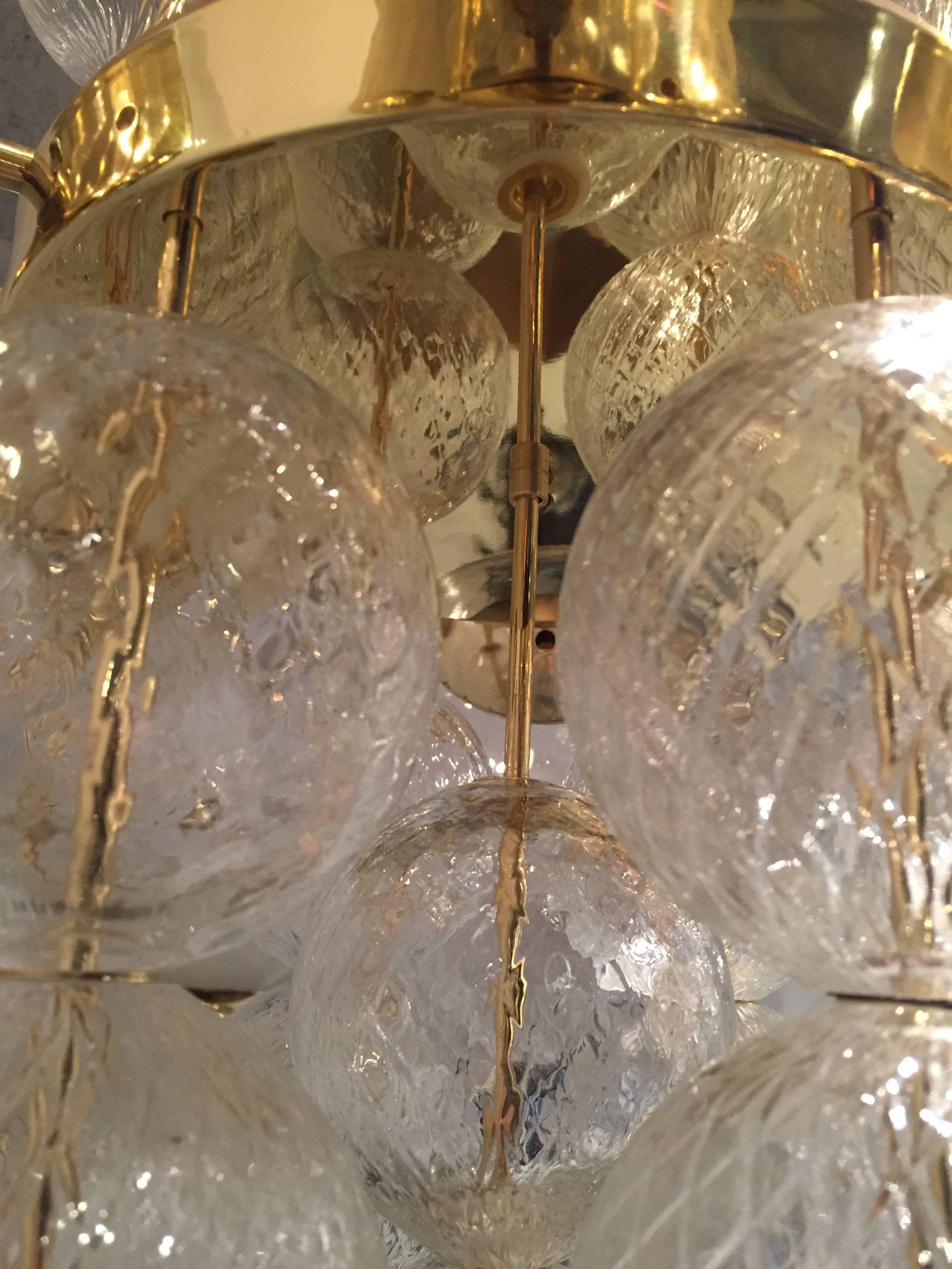 Brass and handblown glass pair of rare chandeliers. Perfect vintage condition, new old stock, only very little marks on the brass, glass are perfect.
Three pairs available.