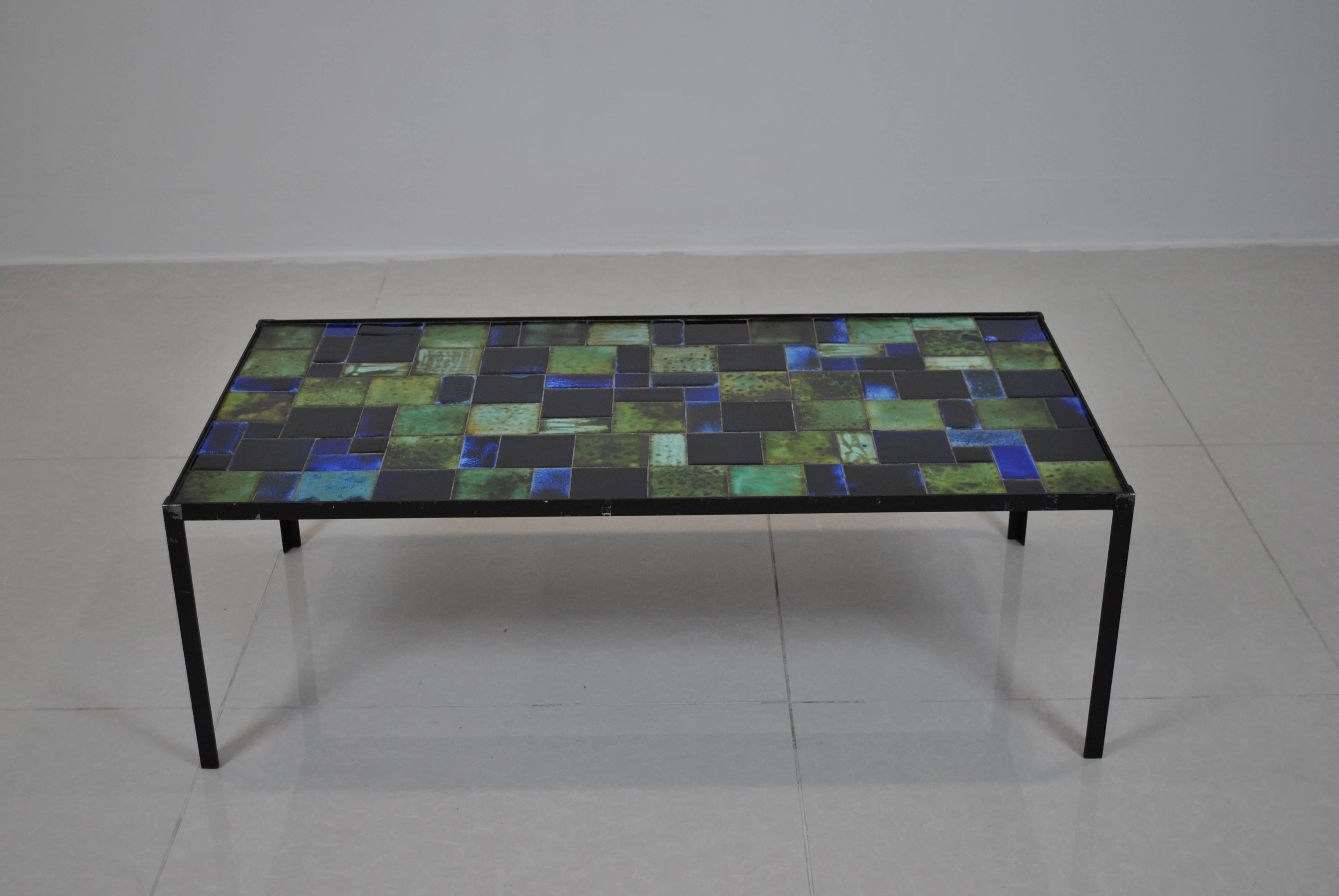 Nice large coffee table by Rogier Vandeweghe/Amphora for Pia Manu. Rare due to its blue and green colors. 

Very good vintage condition with some manks at the original lacquer on the iron. Can be relacquered for free on special demand. The ceramic