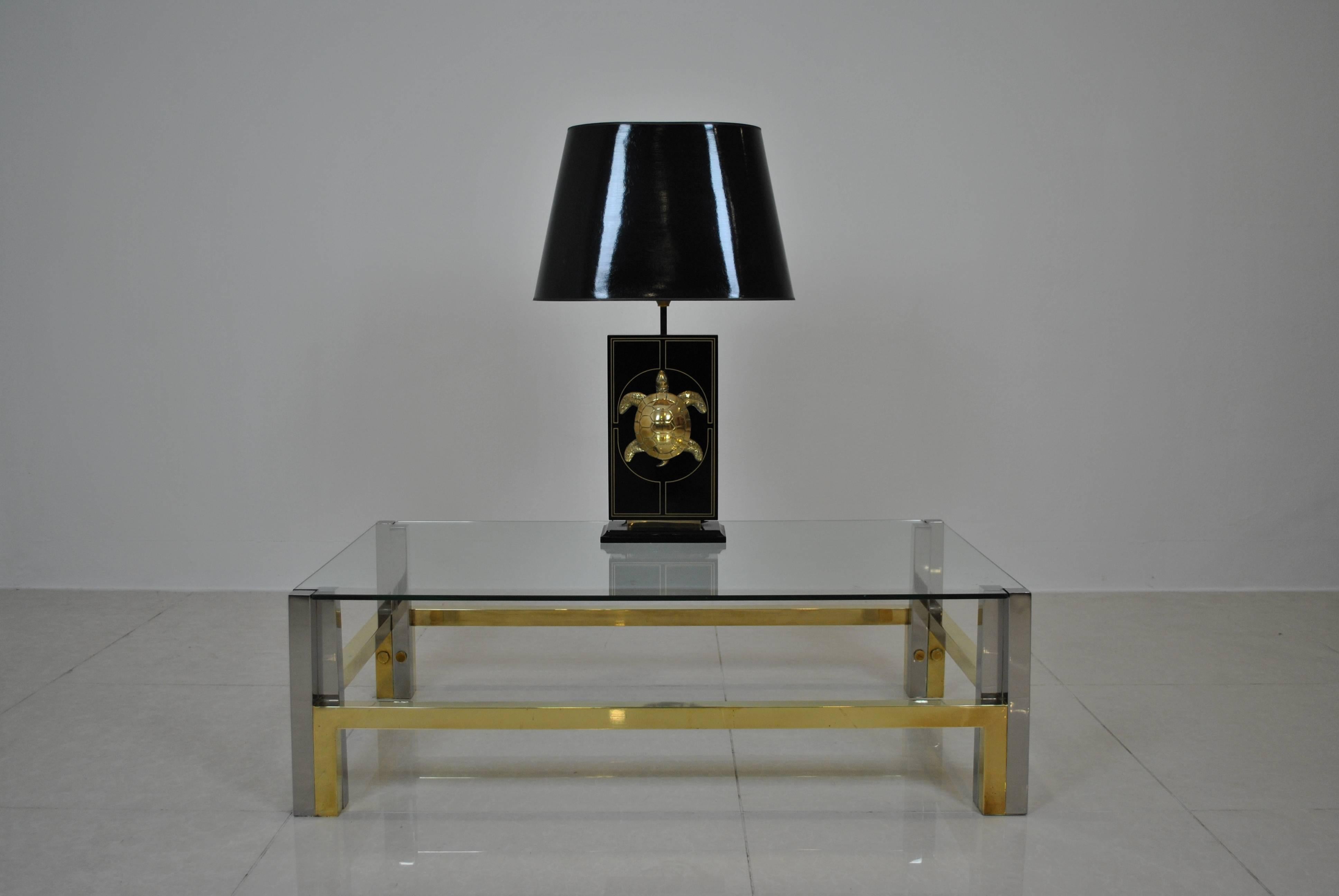 A beautiful and very large black and gold details table lamp with a nice brass turtle on the front. From the 1970s, probably Italian.
A great accent in Hollywood Regency interiors with items from Maison Jansen, Romeo Rega, Aldo Tura or Karl