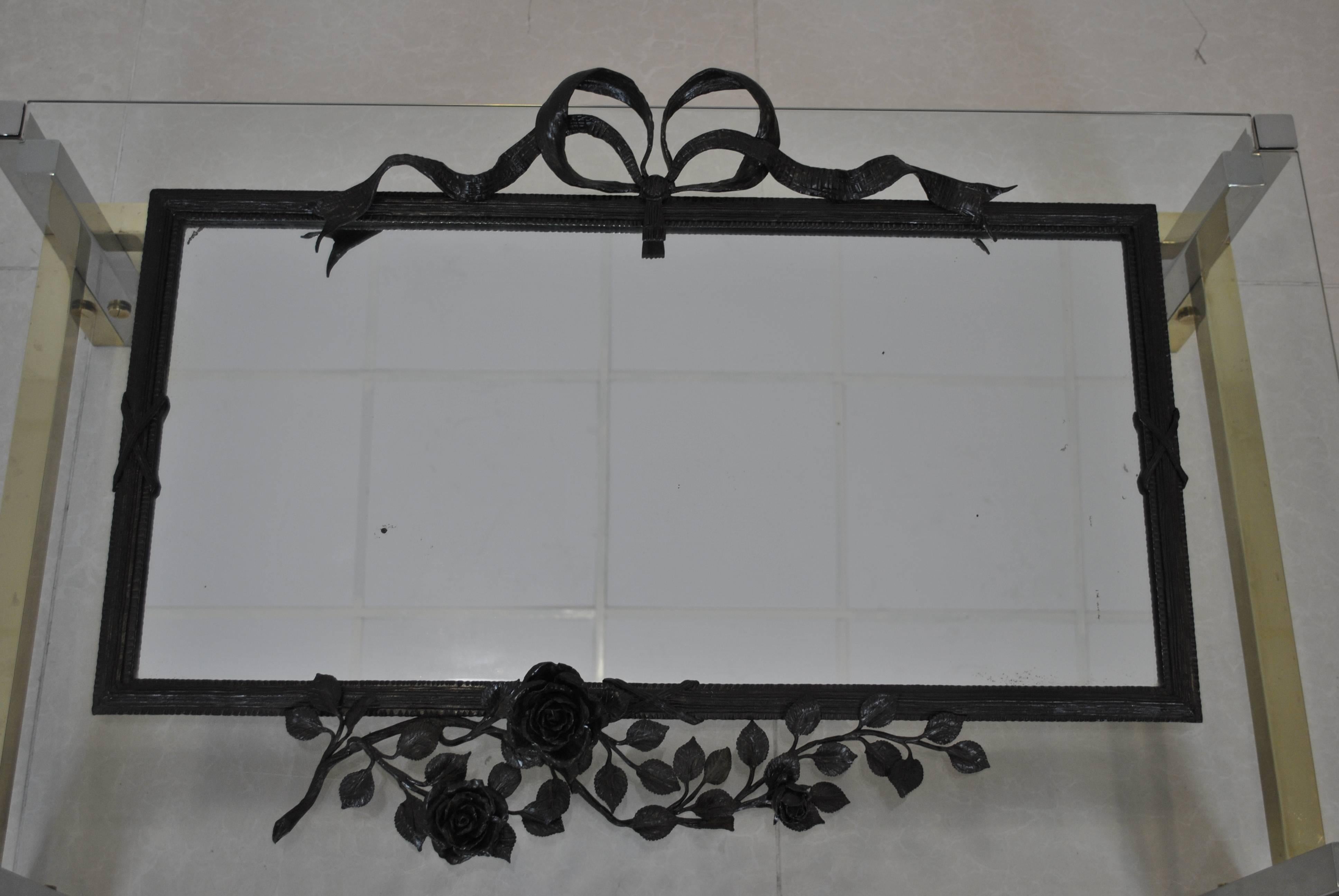 A very nice neoclassical wrought iron and patinated mirror attributed to Louis Van Boeckel. The mirror comes from an Antwerp private estate and is in good antique condition. 
The typical rose decoration is very known for Van Boeckel, good match