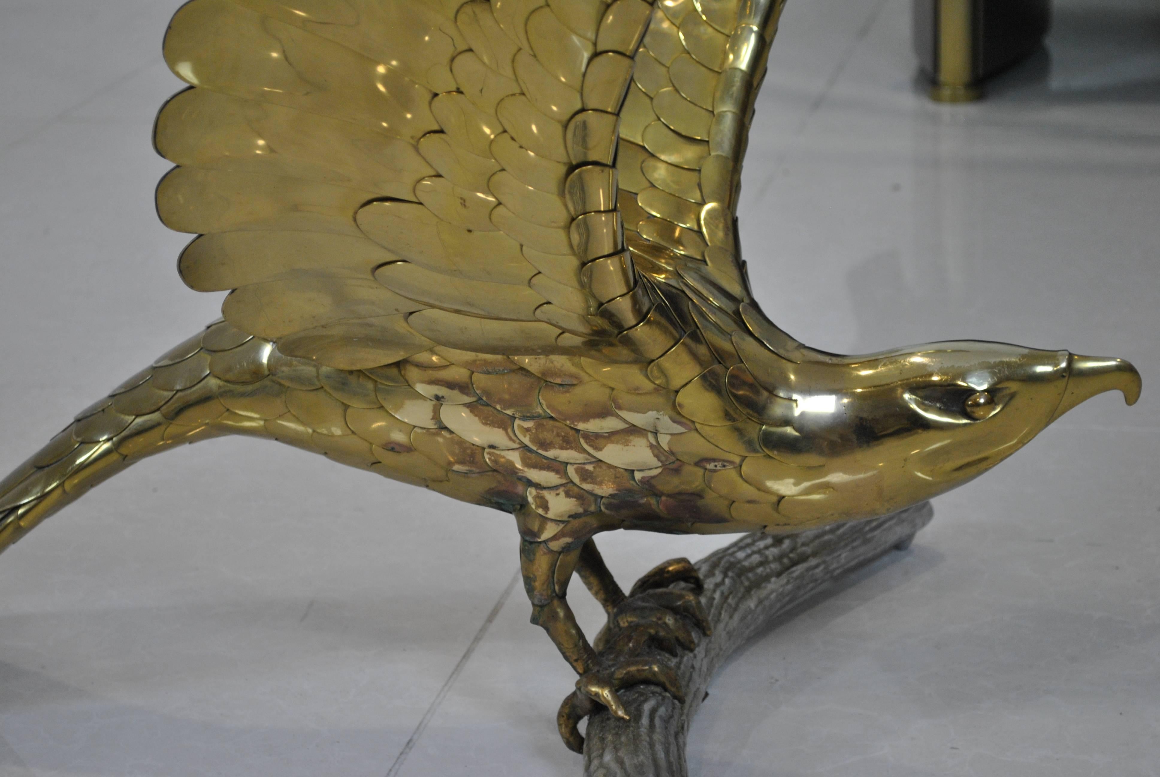 A rare and very large dining table with handmade brass eagles by Alain Chervet, with large thick glass top. The table date from the late 1970s and could work as a spectacular executive desk or center table also. This work is a lot more detailed than