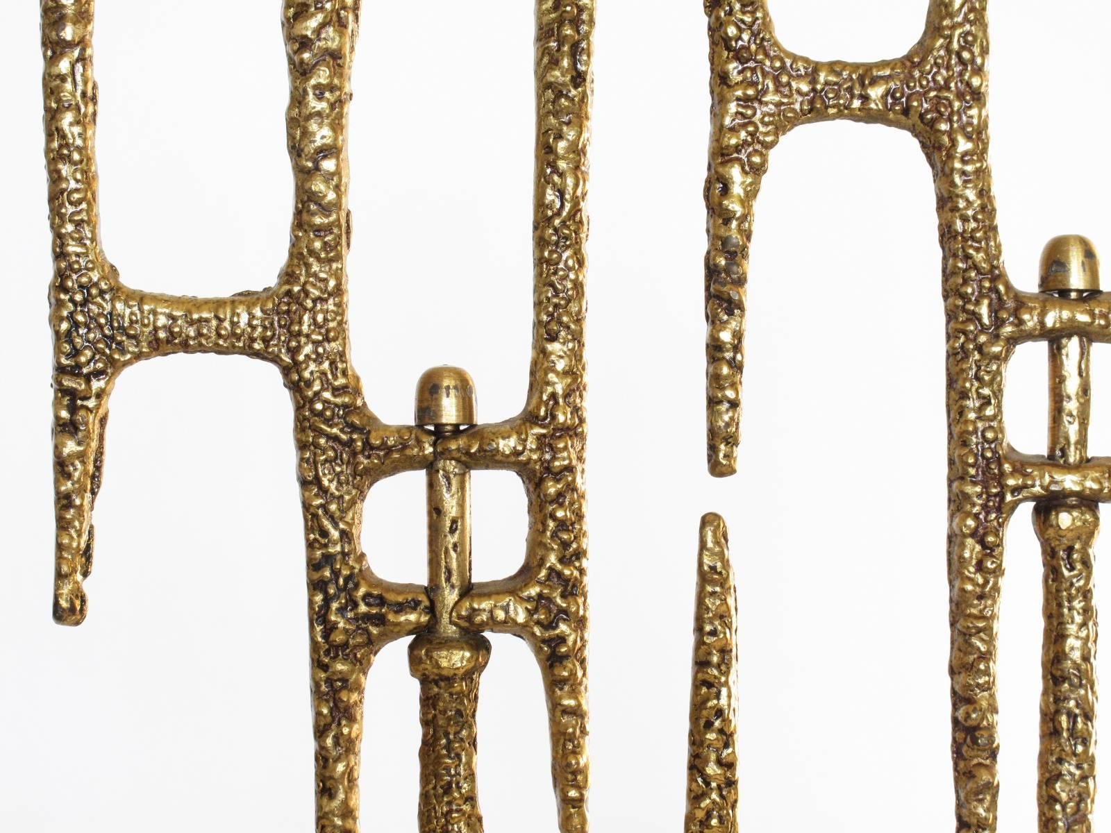 This Israeli Brutalist Modern menorah handcrafted in brass features a lovely beaded texture along the surface and nine candleholders which rotate along the articulating stems, designed and made by Wainberg, Israel, 1970s.

Dimensions: 13.25 high x