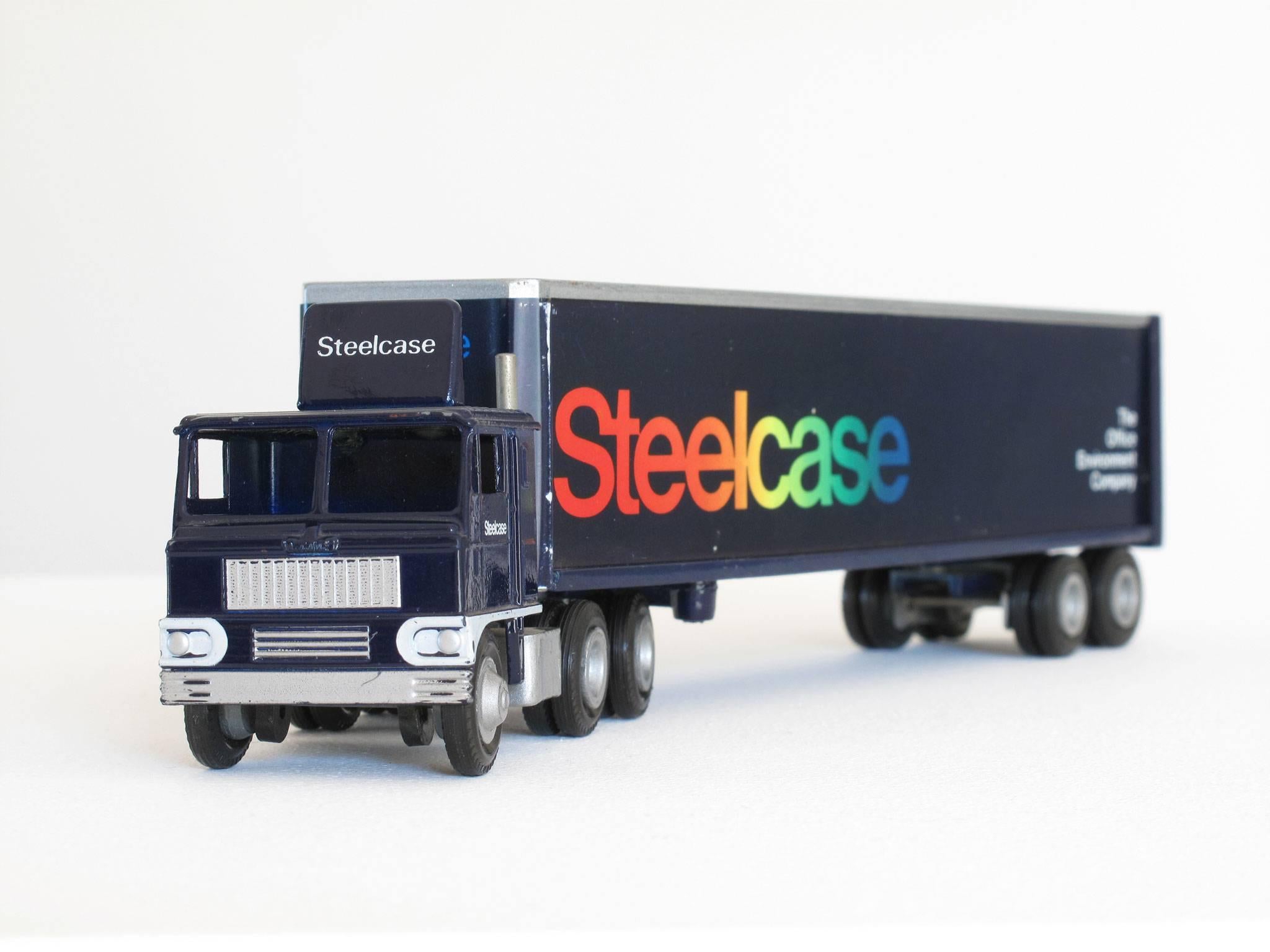 Fun, collectible Steelcase Furniture miniature truck advertising, 1:64 scale model, navy blue semi-truck with cab and trailer and multi-color logos, made of die cast metal, paint, plastic.
Dimensions: 2 3/8 high x 9 1/4 wide x 1 1/2 deep