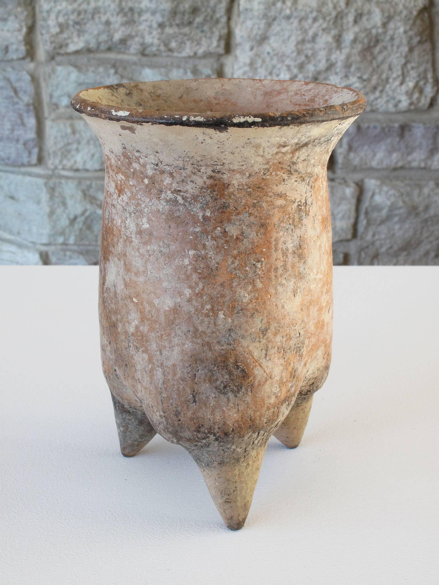 Fascinating glazed pottery piece with cylindrical form and flared rim standing on three, pointed, conical supports, most likely earthenware and made by the Xiajiadian Culture from Inner Mongolia, circa 2300-1600 B.C. Dimensions: 7 5/8 high x 5 1/4