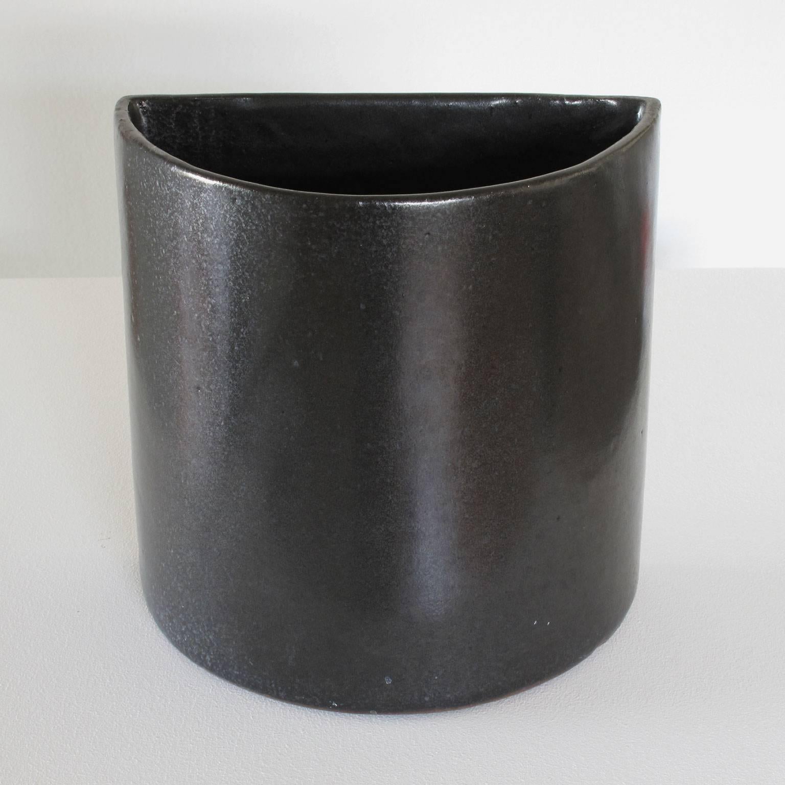David Cressey 'wall pocket' ceramic planter with flat back to be mounted flush onto wall, stoneware, glazed black, 1960s, Pro Artisan Collection, Architectural Pottery, Los Angeles, California, 8 high x 8 wide x 5 deep inches, in excellent vintage