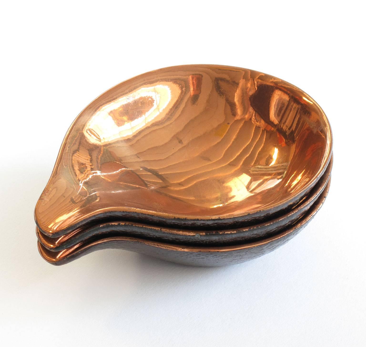Three biomorphic copper plated metal nesting cups (saucers or ashtrays) designed by Ben Seibel, 1950s, each measures 1 high x 3.75 wide x 4.5 deep inches, Jenfred Ware, New York, excellent vintage condition, copper shines and reflects nicely,
