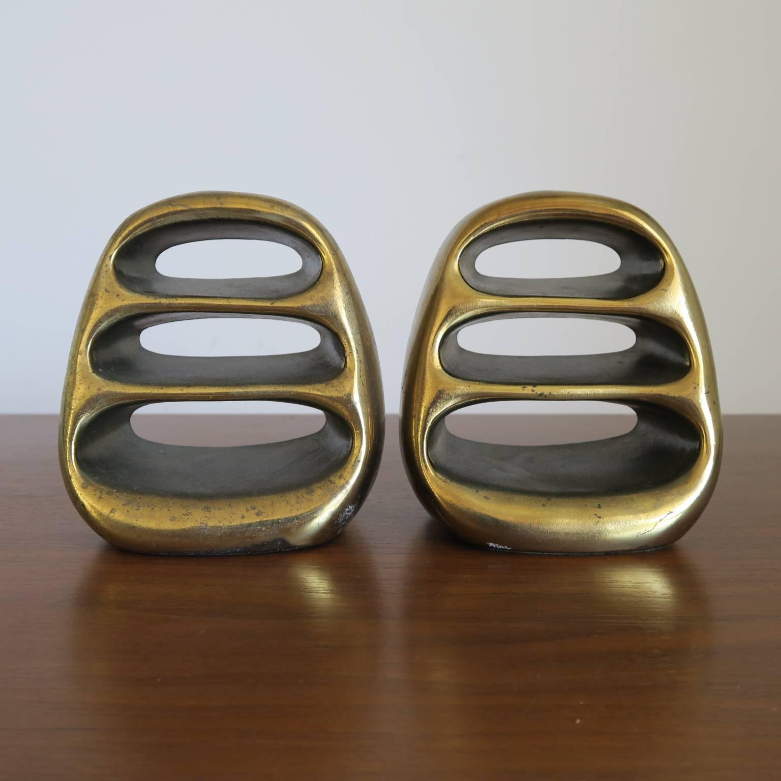 Ben Seibel bookends in brass-plated cast metal, circa 1950s, good vintage condition, each measures 5 high x 4.5 wide x 3 deep inches.