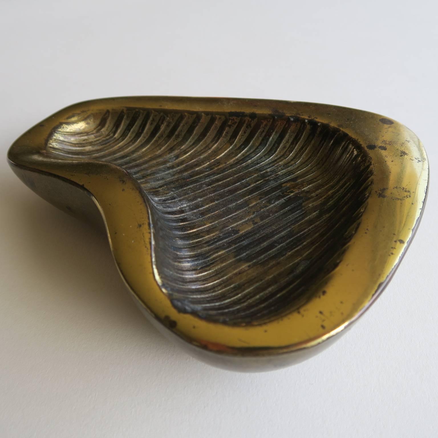 Ben Seibel dish with lines design, brass plated cast metal, originally designed for use as an ashtray, decorative and functional, circa late 1950s, 1 1/4 high x 5 3/4 wide x 4 1/2 deep inches.
