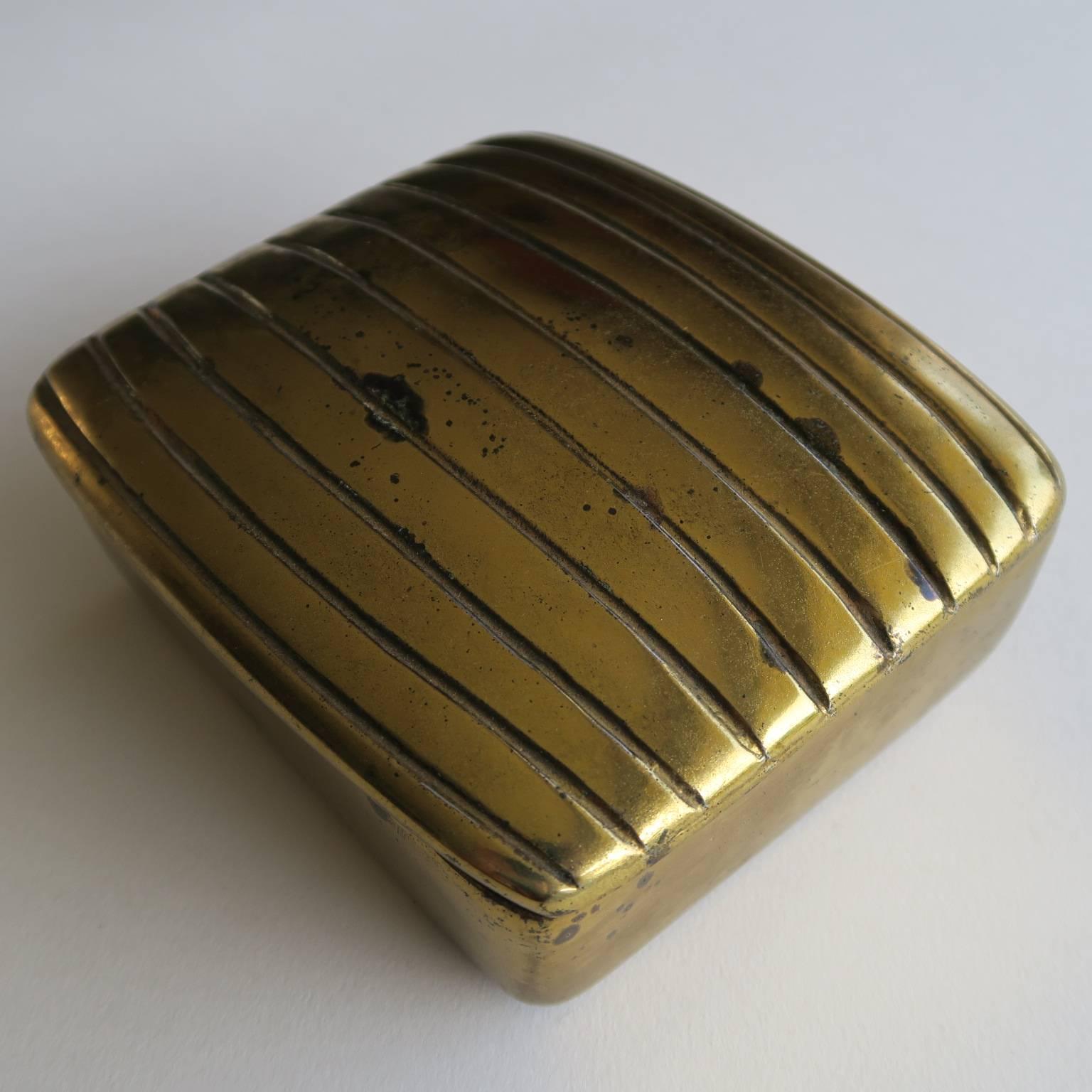 Ben Seibel box, brass-plated cast metal, cork lined interior, felted bottom, 1950s, 2 high x 4 1/2 x 4 inches.