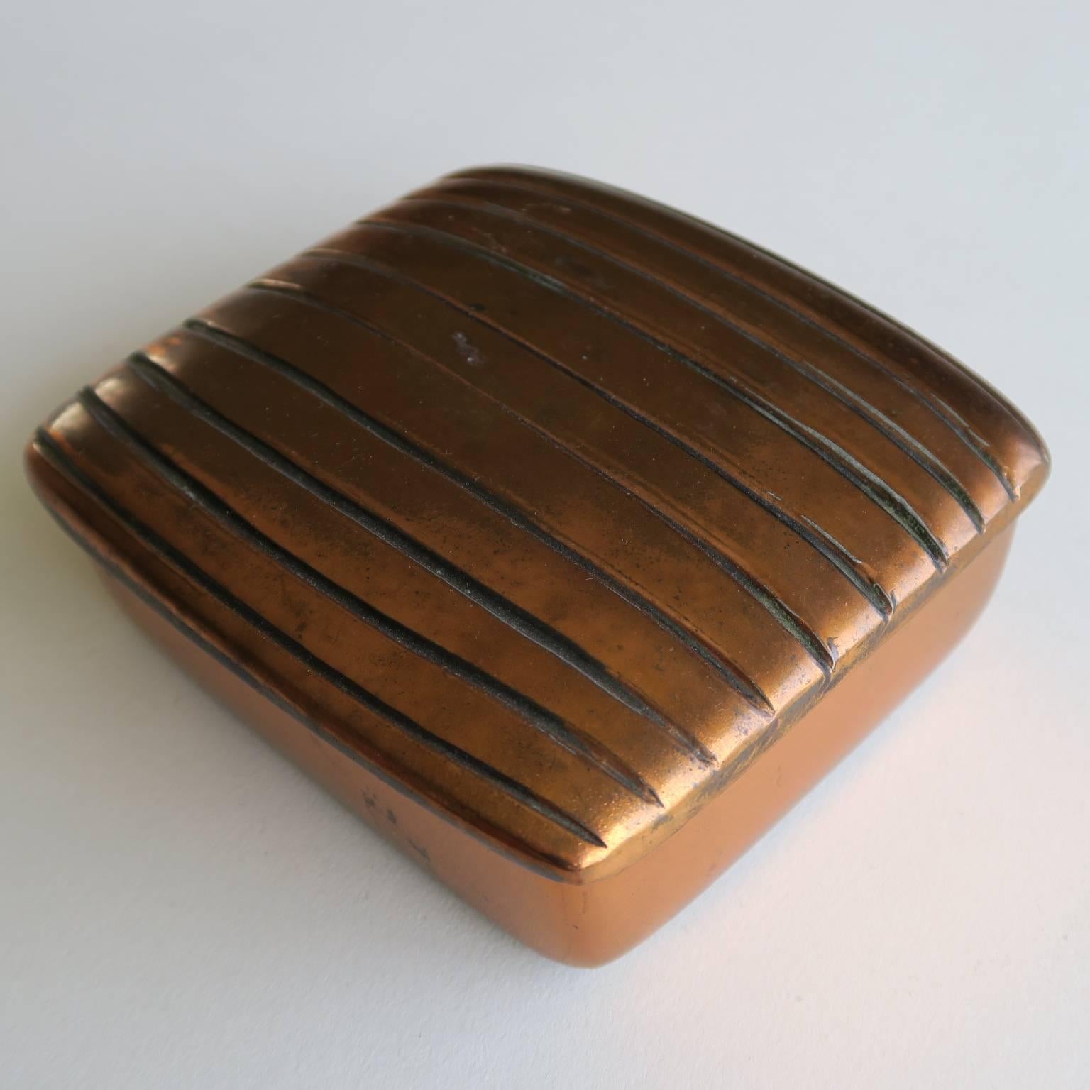 Ben seibel box, copper-plated cast metal, cork lined interior, felted bottom, 1950s. Measures: 2 high x 4 1/2 x 4 inches.