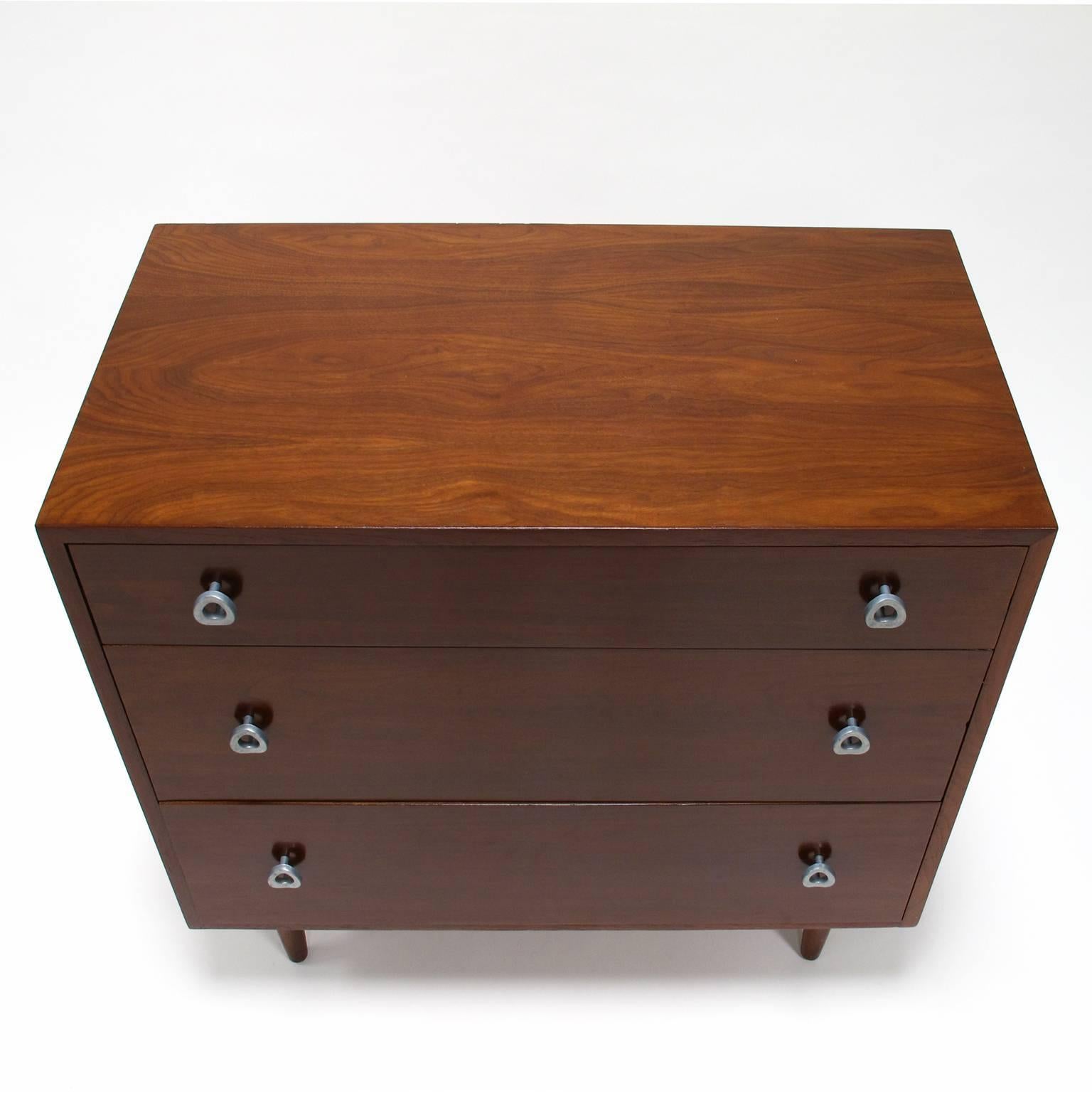 Greta Grossman dresser, three-drawer chest of drawers in rosewood with steel handles, a classic California modern design, Glenn of California, 1950s, 32.5 high x 33 wide x 18 deep inches, in very good vintage condition.