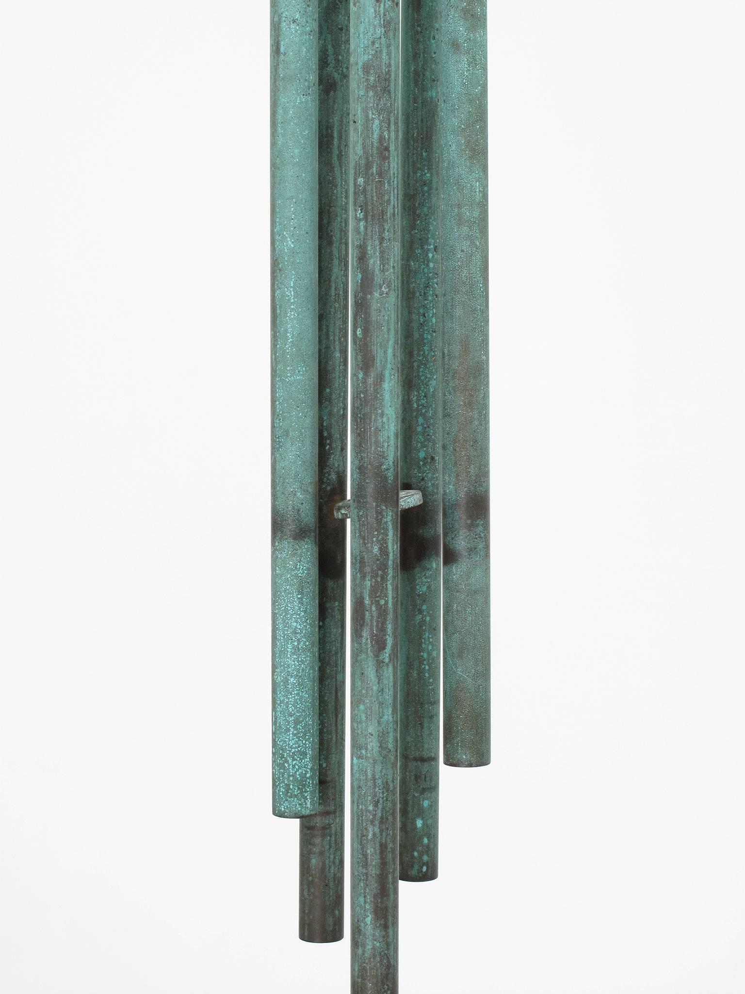 Mid-Century Modern solid brass wind chimes with a beautiful patina and creating a wonderful rich sound, measuring 29 high x 4 diameter inches.