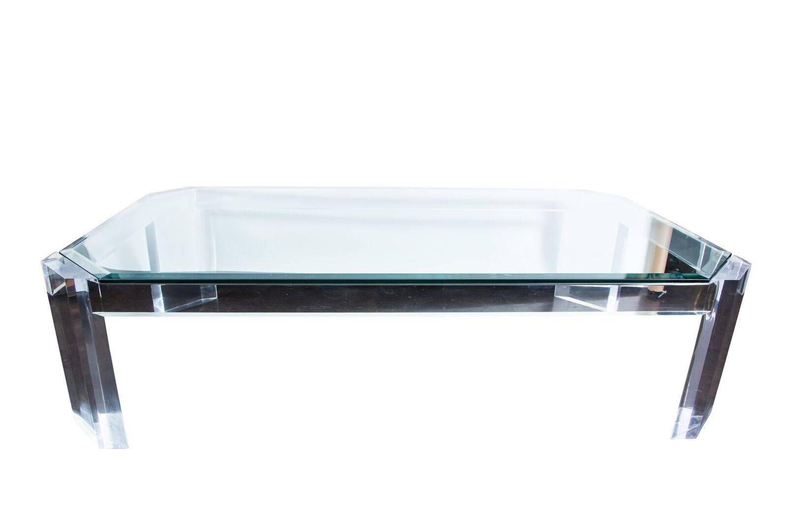 Fabulous coffee table comprised of thick and heavy pieces of Lucite attributed to Charles Hollis Jones. New custom, beveled glass top. A glamorous addition to any modern decor.