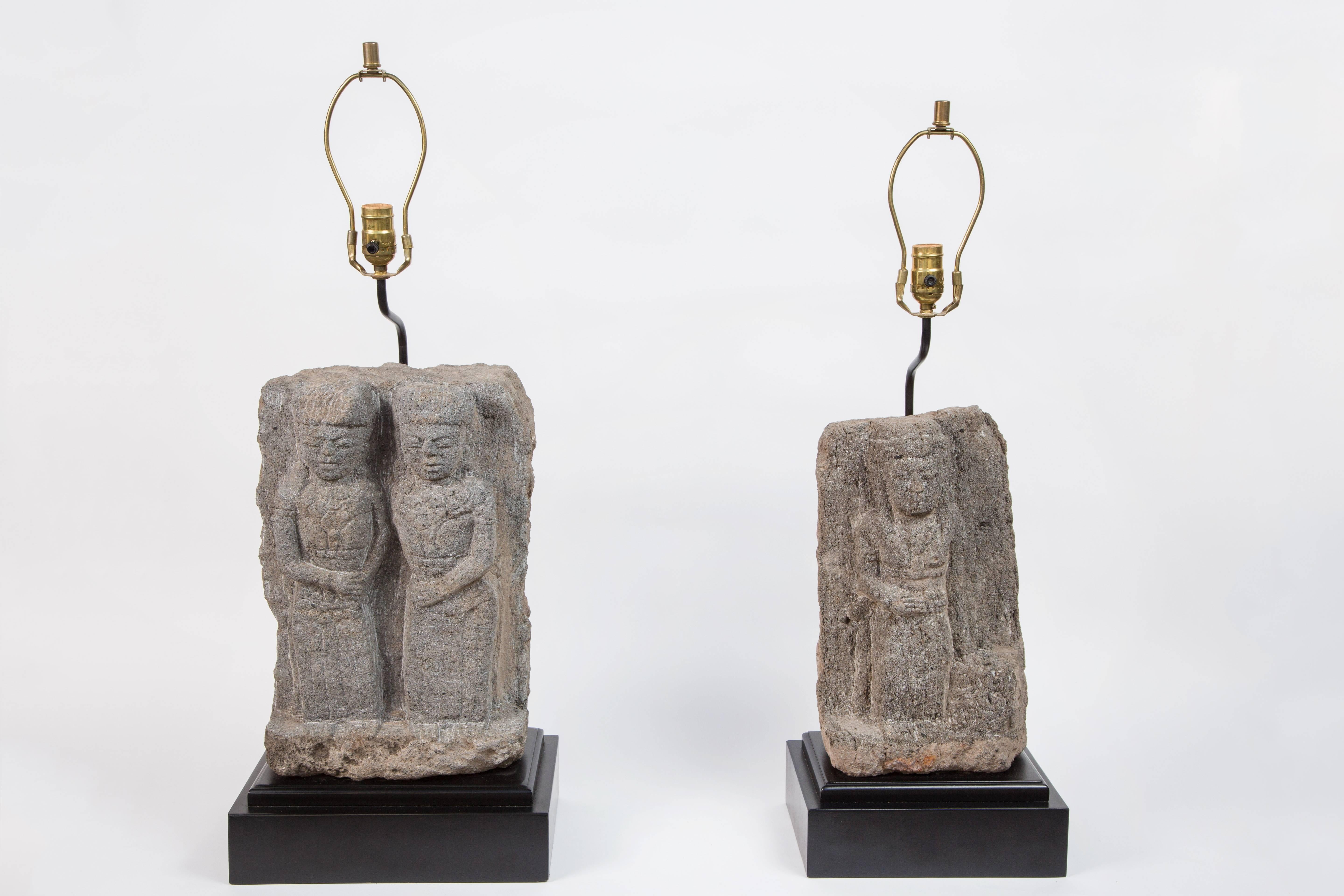 Pair of stone fragment lamps. Central American stone fragments are over 300 years old and have been mounted onto wood bases.  Lamps have been fully wired.  Fragments differ in size and height but can be successfully used together or separately. 