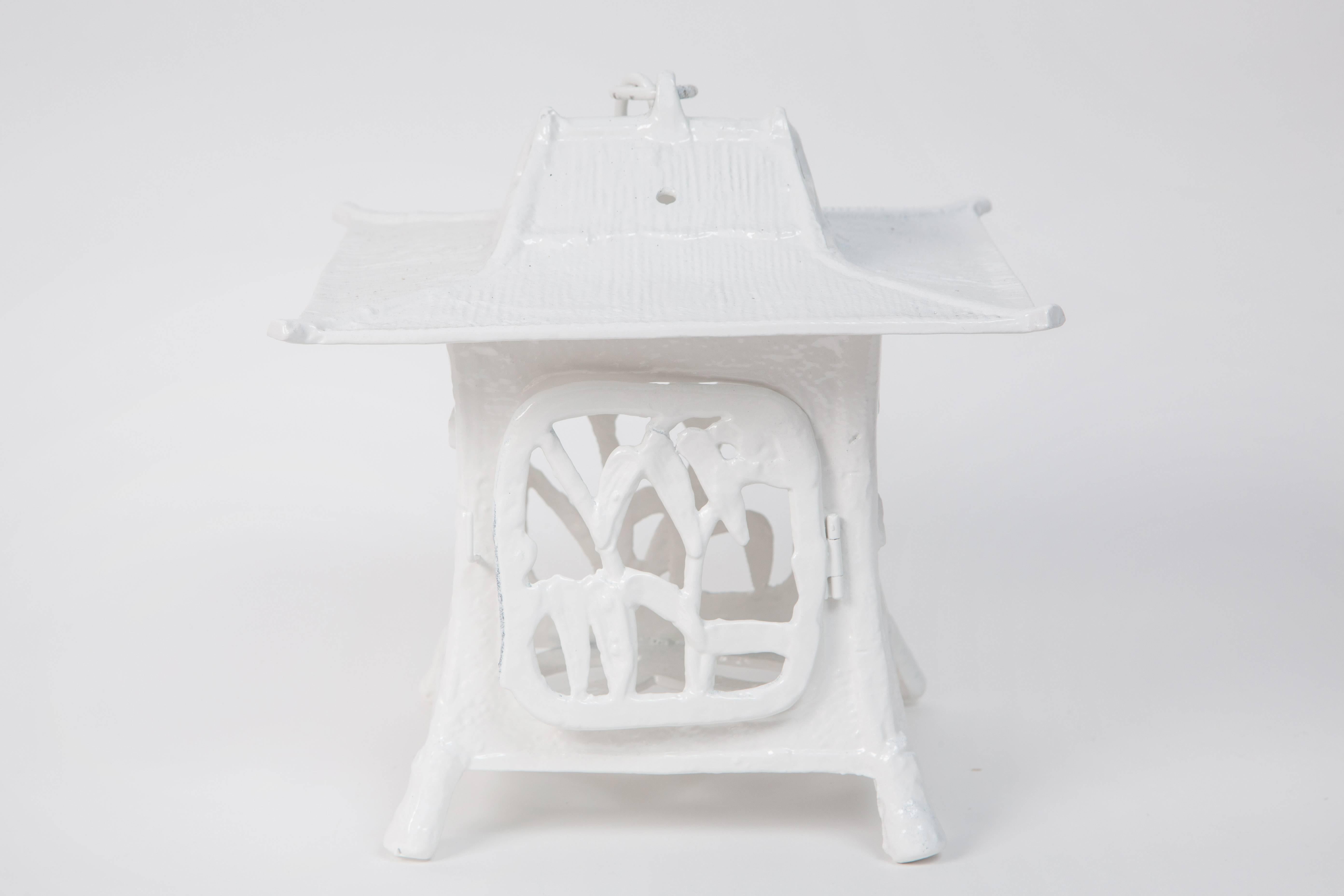 Chic set of three cast iron pagodas from the 1960s re-imagined in white hi-gloss lacquer. Can be used as display pieces or hanging lanterns (metal canopies are included).

Dimensions:
9