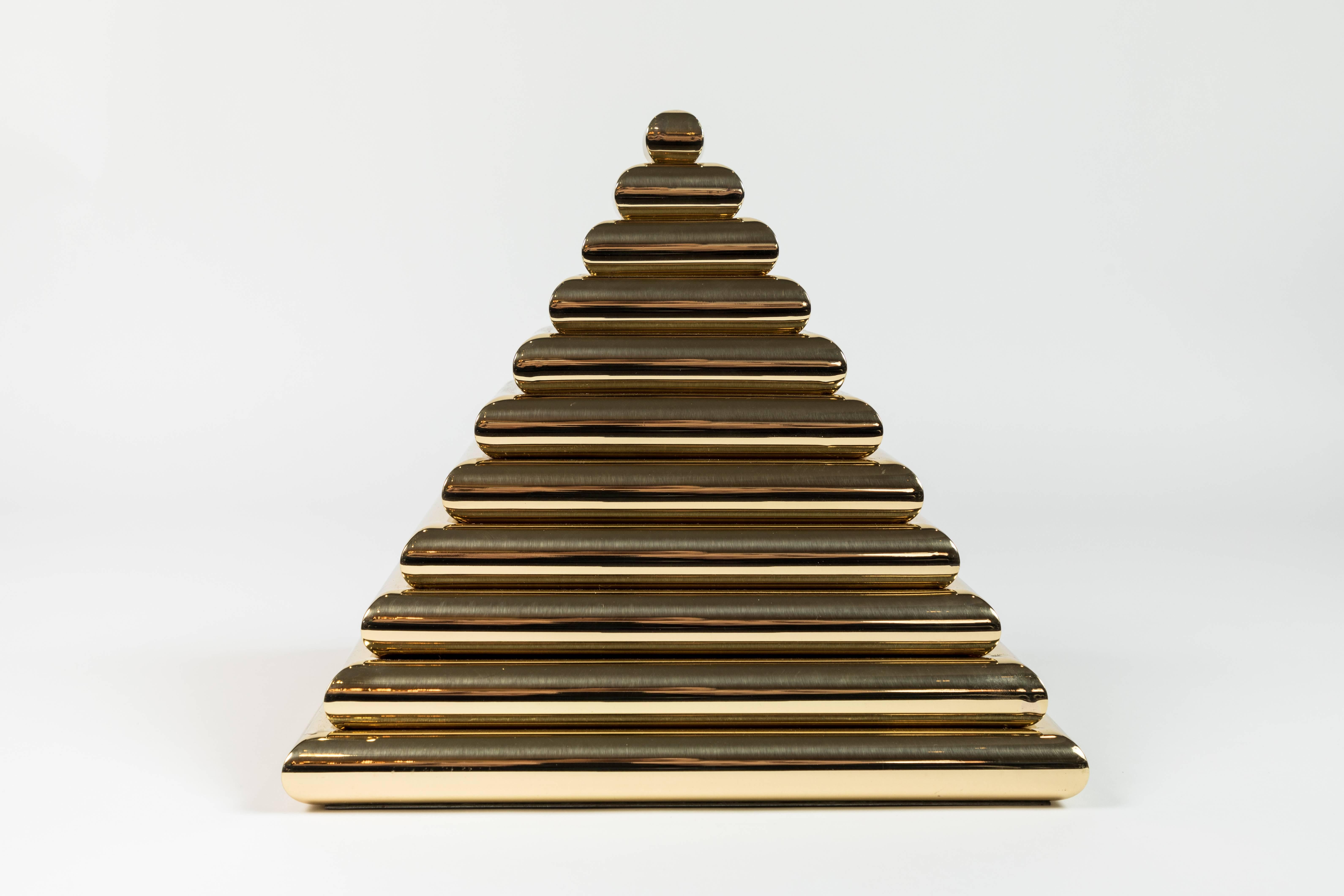 Striking pyramid shaped box in polished brass, Italian, circa 1970s. Top portion of box can be removed to reveal a storage compartment. Professionally polished.