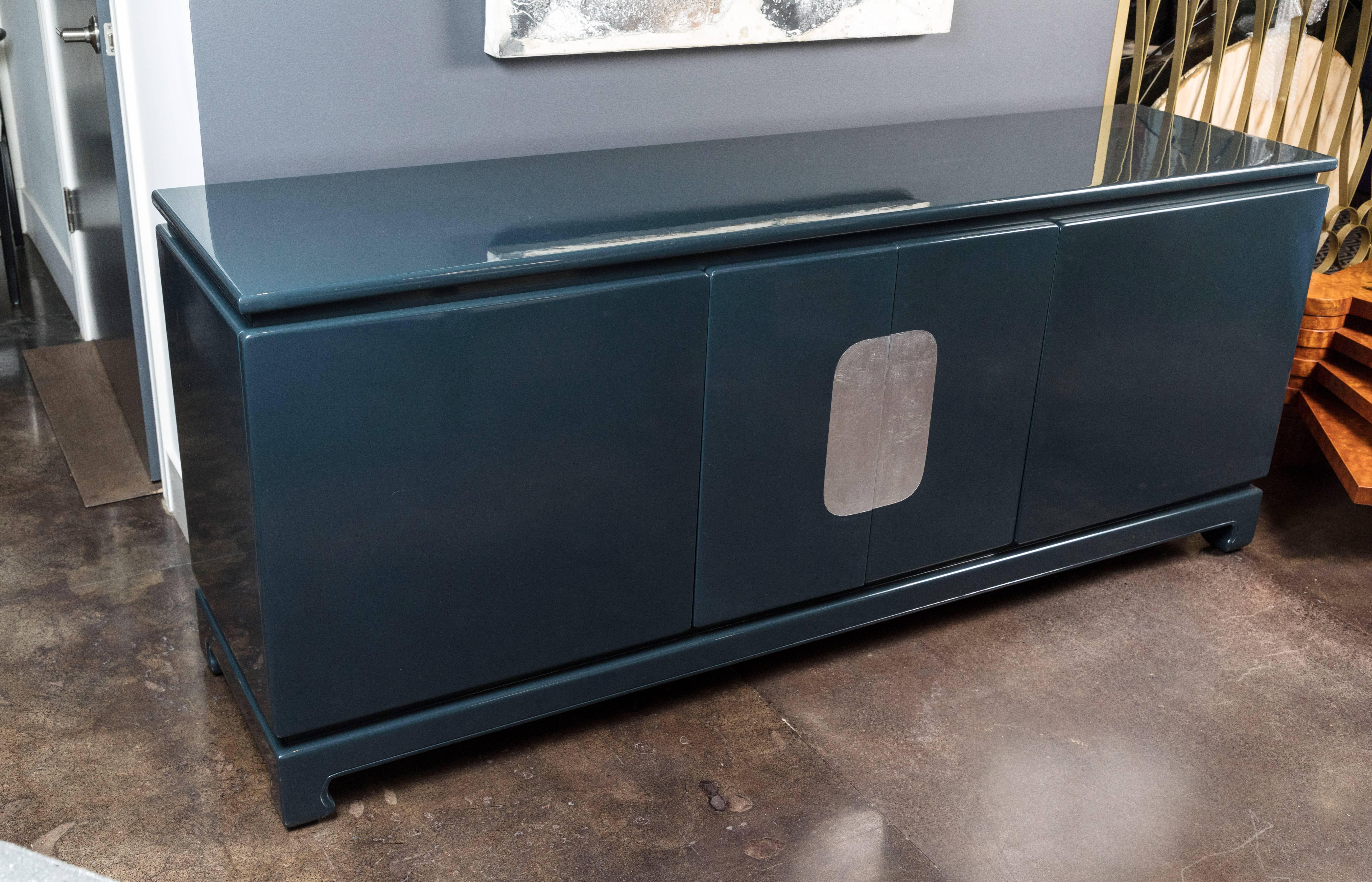 Sleek, modern sideboard with a bit of an Asian influence, early 1980s. The sideboard is substantial in size and has lots of interior storage. It has been newly lacquered in the Farrow & Ball color black blue.