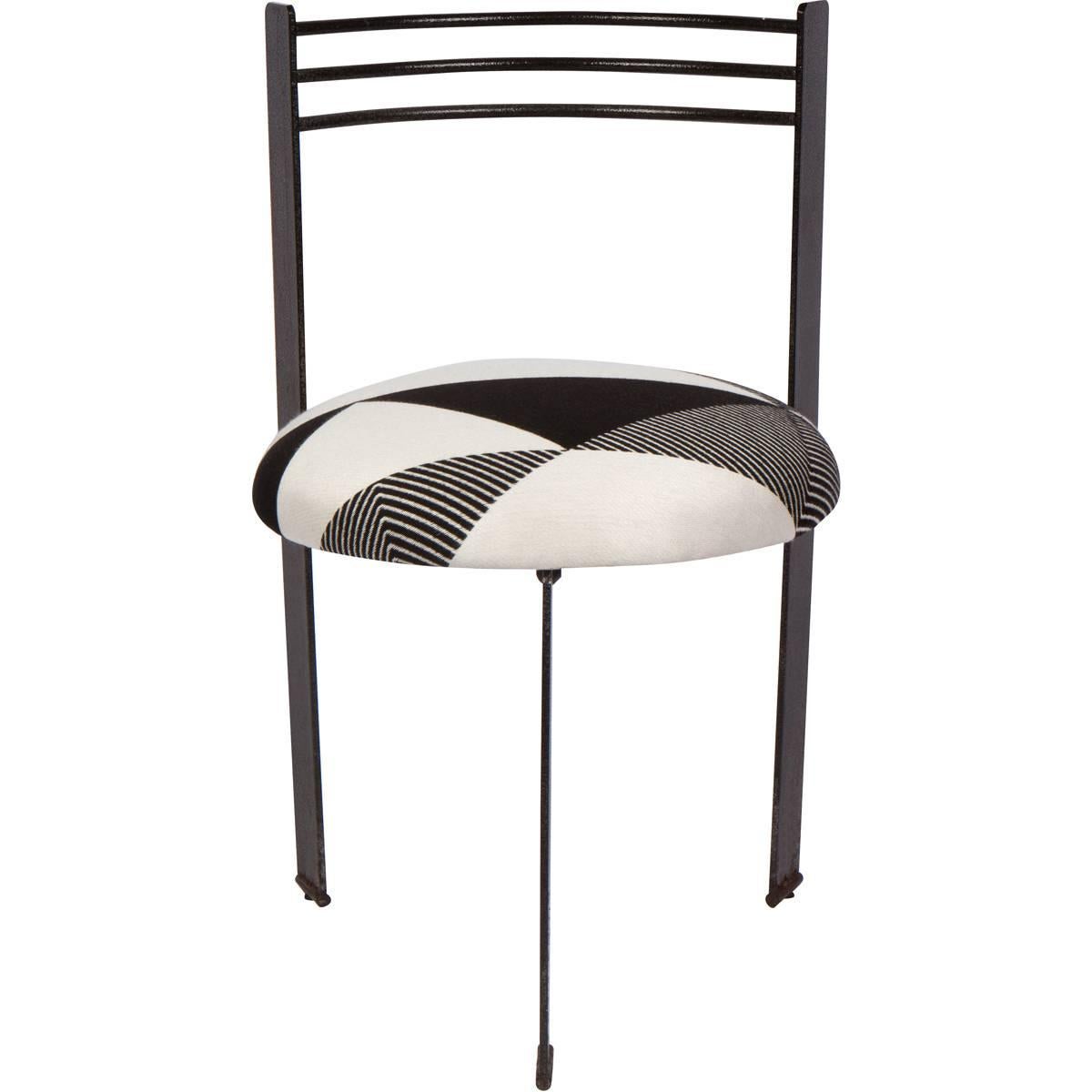 Chic set of four metal dining chairs inspired by the Memphis style, 1980s. The chairs are quite heavy and have a slightly textured, deep charcoal finish on them. They have been newly re-upholstered in a high end geometric black and white Kirby