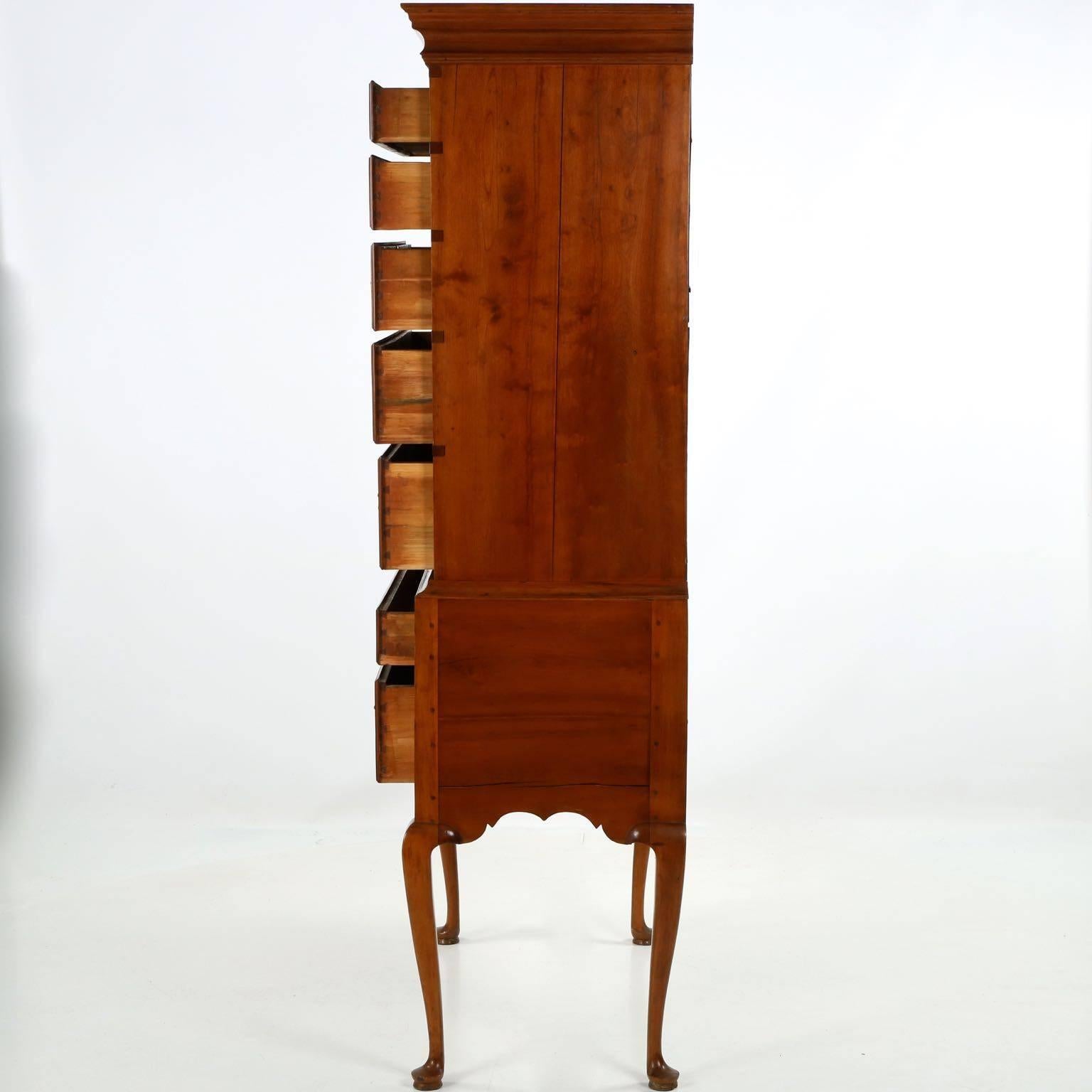 This fine and incredibly striking work of art is distinct for the austerity of the form set against a most lively scroll cut apron. Entirely original, though carefully refinished during the last century, the highboy survives in simply outstanding