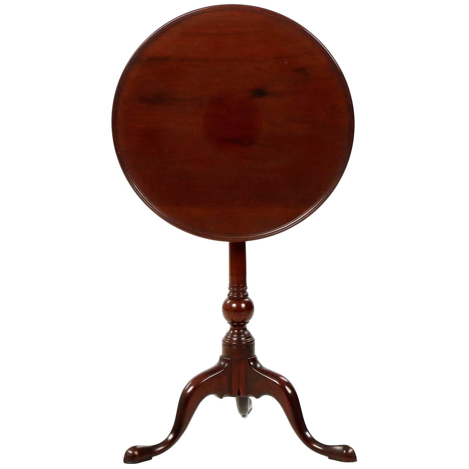 A most attractive American Queen Anne mahogany candle stand from the Philadelphia area, circa the last quarter of the 18th century, the table is particularly striking for the diminutive and fully developed suppressed ball at the bottom of the long