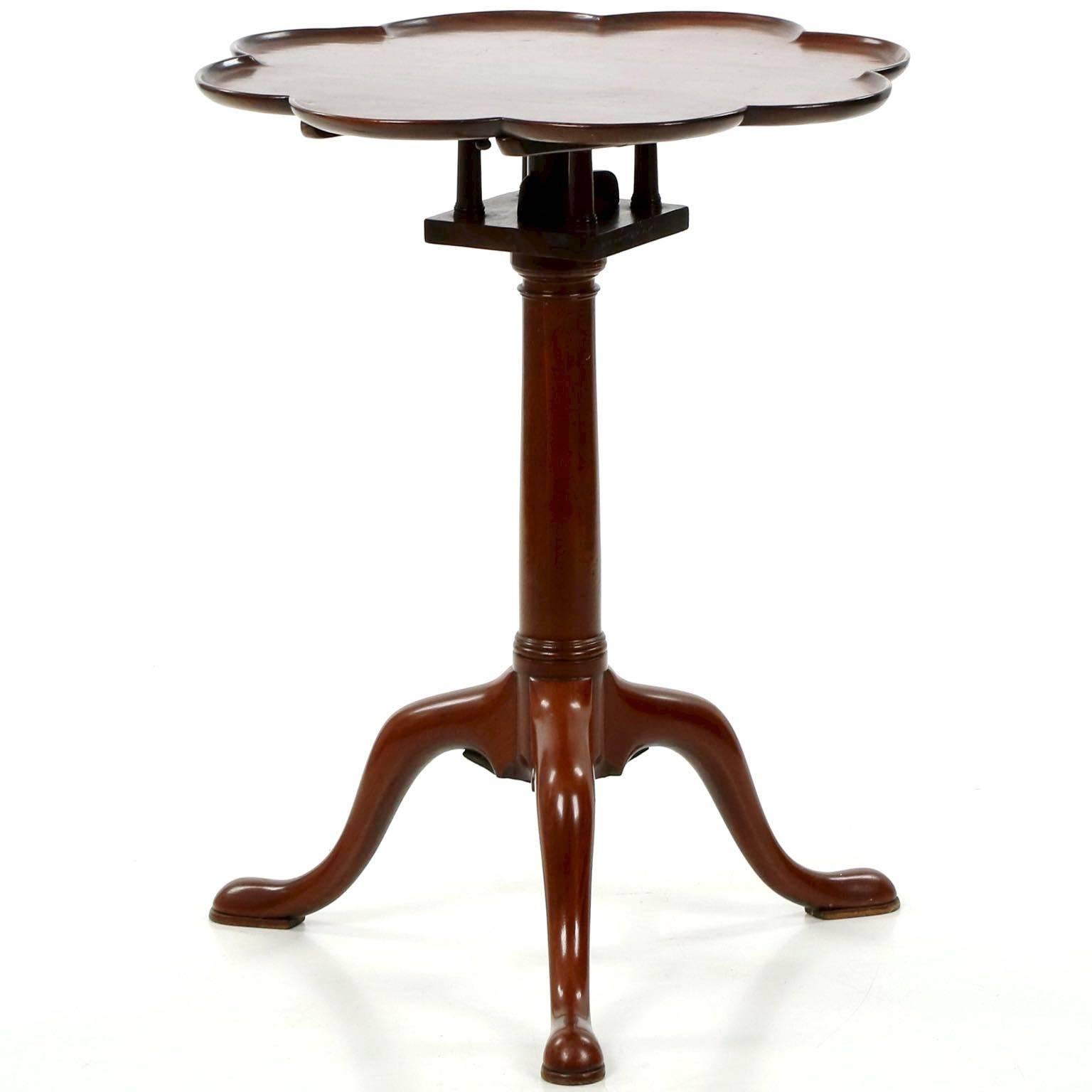 An attractive little table crafted of mahogany, the octofoil top is particularly distinctive; the form was generally used to allow service of tea, where the saucers could rest in each of the turrets with the pot at the center of the table. On these