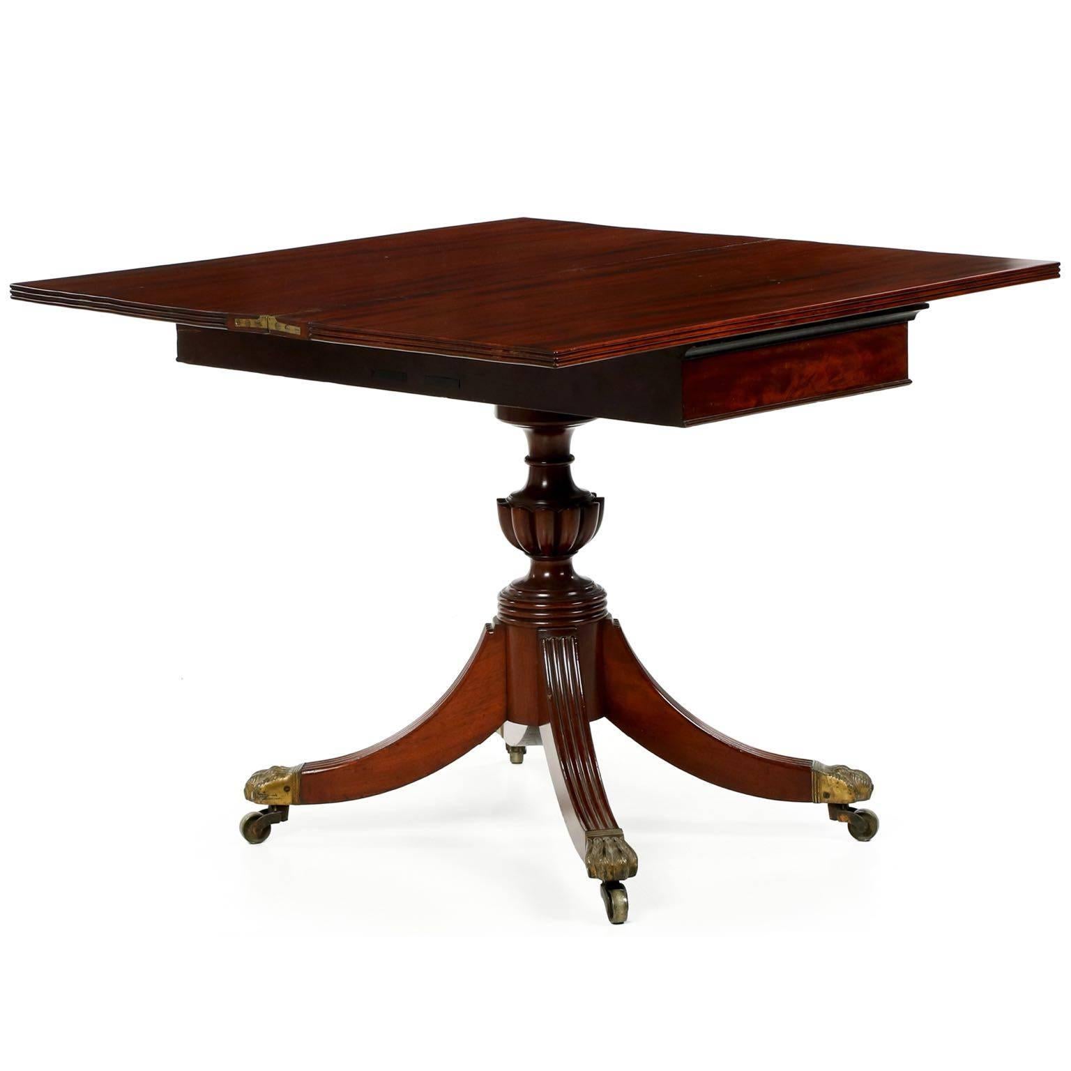 An example of the very fine craftsmanship of the Baltimore furniture center, the cabinet work of this table is pristine and of the highest quality. Using full board mahogany for both leaves, the warm long grain planks are French polished with a