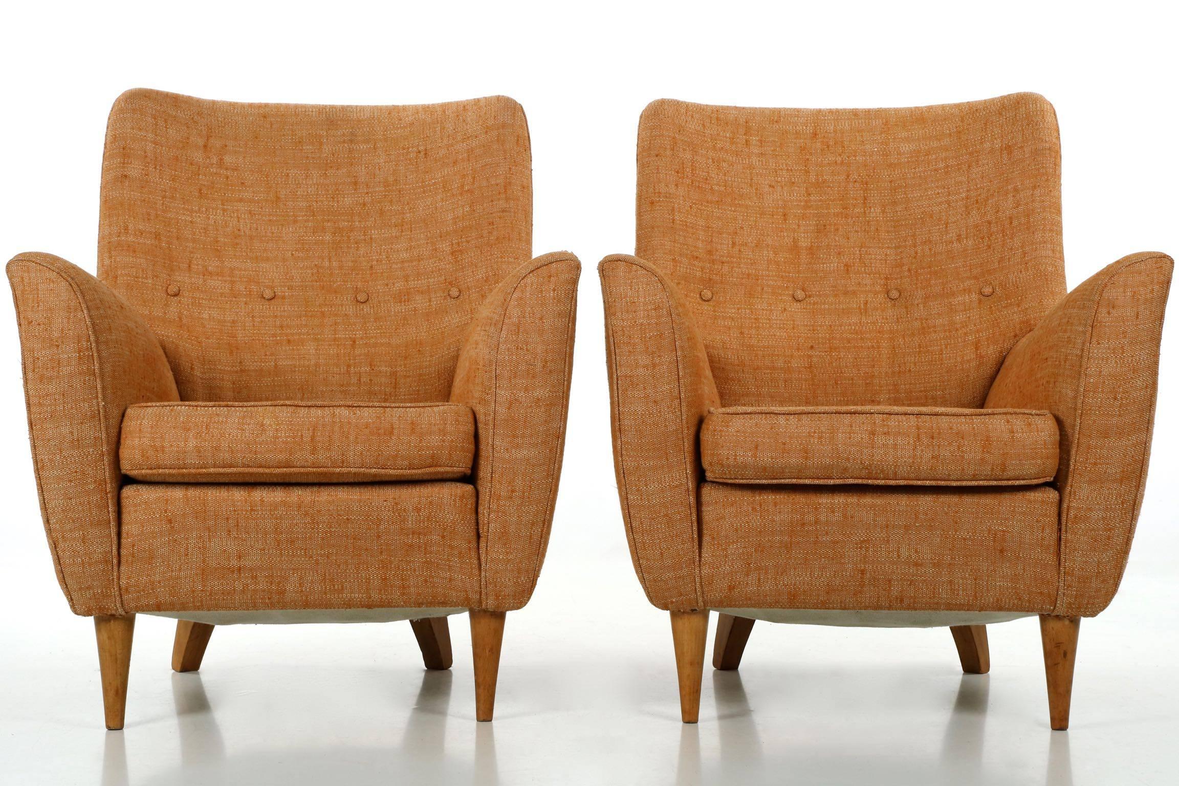 An absolutely gorgeous form in this pair of Italian sculpted beech club chairs, the bow of the back is matched in the subtle outward curvature of the arms despite being a club chair in design, the footprint is petite and visually reduced by the