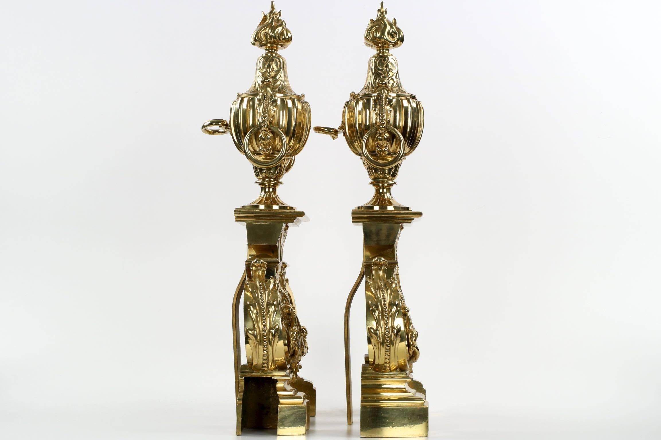 An incredibly intricate and finely cast pair of chenets by the firm of Ferdinand Barbedienne, these make a powerful statement in the classical interior. The polished brass surface is nearly mirror grade in quality, the quality of the casting being