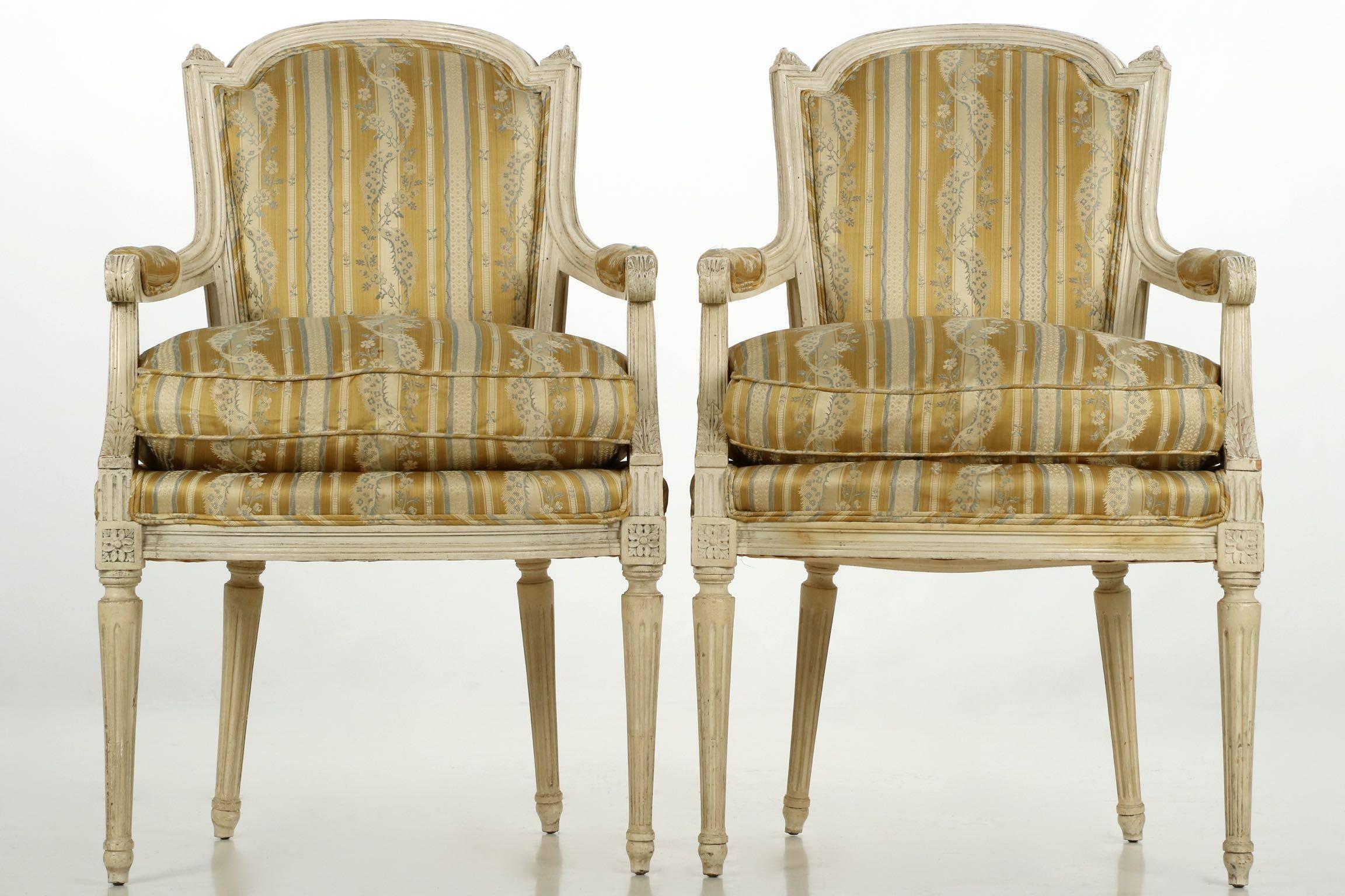 A most attractive pair of early 20th century armchairs, these closely mirror the original form of the late 18th century, the handcrafted frames with the pegged tenon-mortised joinery that made the originals so long lasting. The tight hand carving in