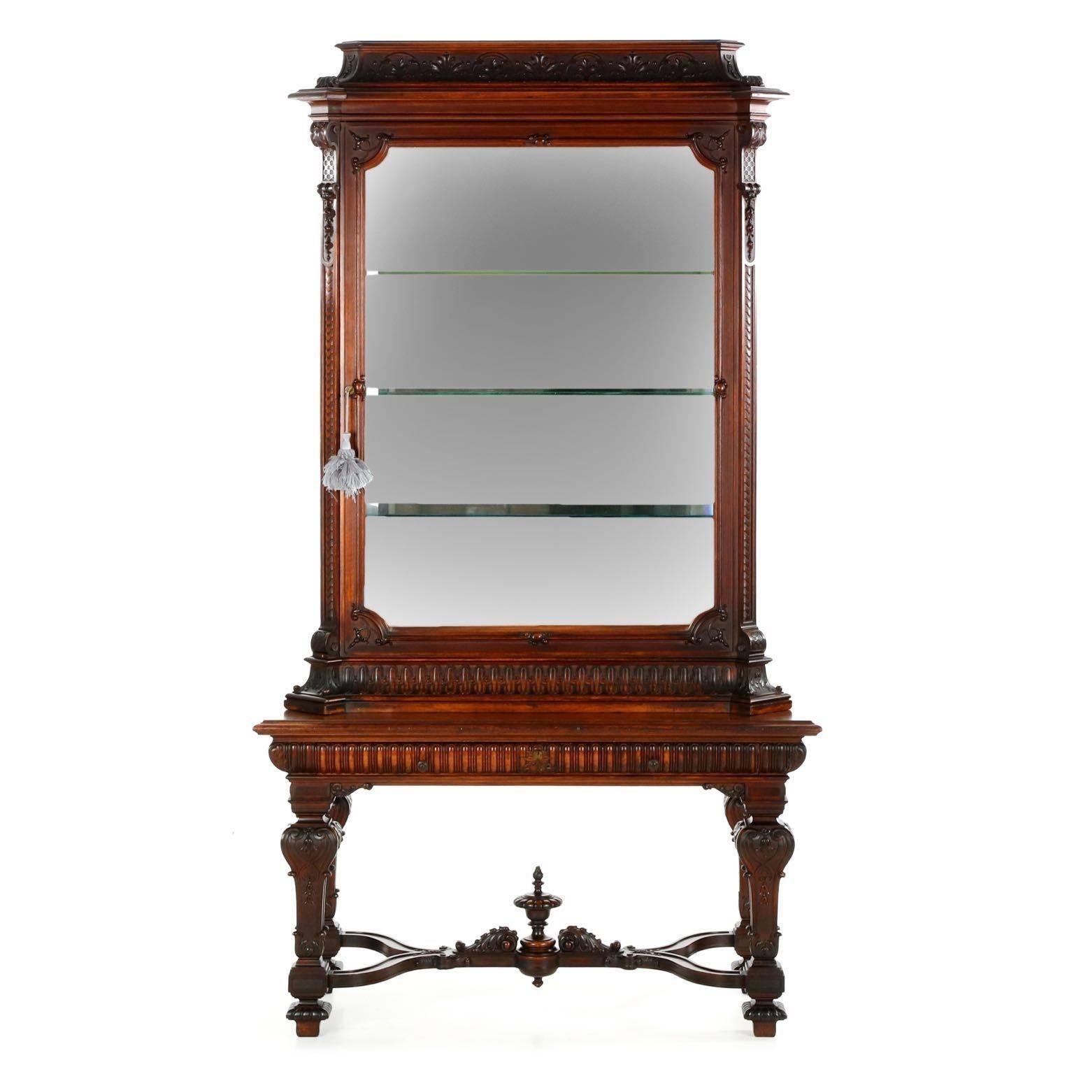 A rather unusual and inordinately fine work of the late 19th century, this display cabinet was crafted in two parts with the loose influence of Rococo evident in it’s form and motifs. The surface treatment is positively exceptional, the carver