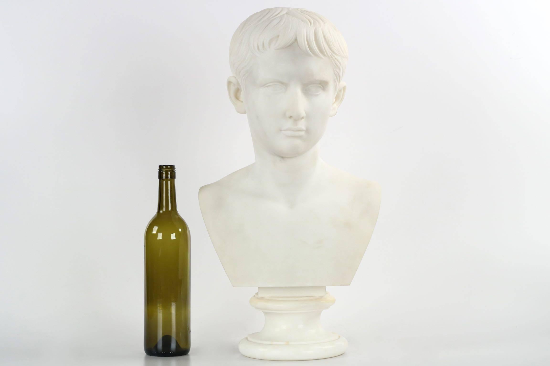 A fine and striking marble sculpture, this bust is thought to capture the pose of a young Caesar Augustus. It is crisply executed, the hand carving finished quite beautifully on a finely selected block of marble with it's pure white surface. The