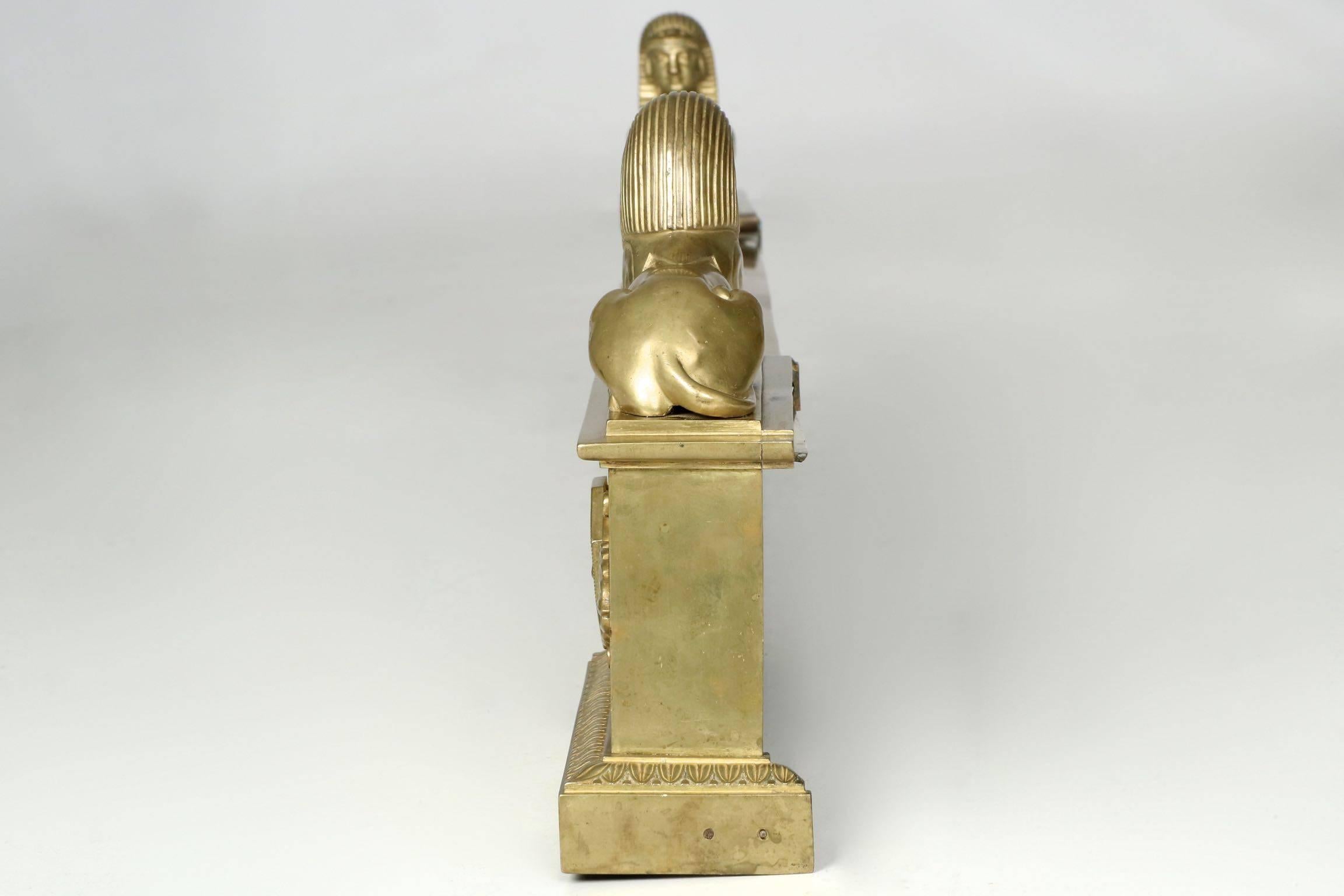 This fine angular fire fender is a beautifully cast solid brass display in the Egyptian taste. The powerful and muscled Sphinx surmount either corner over a stepped plinth. An austere fender body allows it to meld seamlessly with any number of