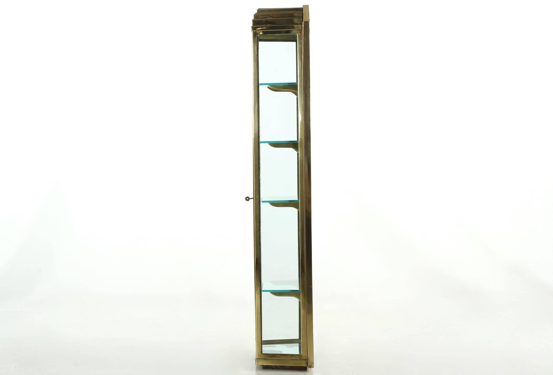 Clearly a custom piece, being of excellent quality and craftsmanship, this fine vitrine is angular and austere, it relies purely on an outstanding form for impact. The entire body is crafted of brass with beautifully welded joints under a more